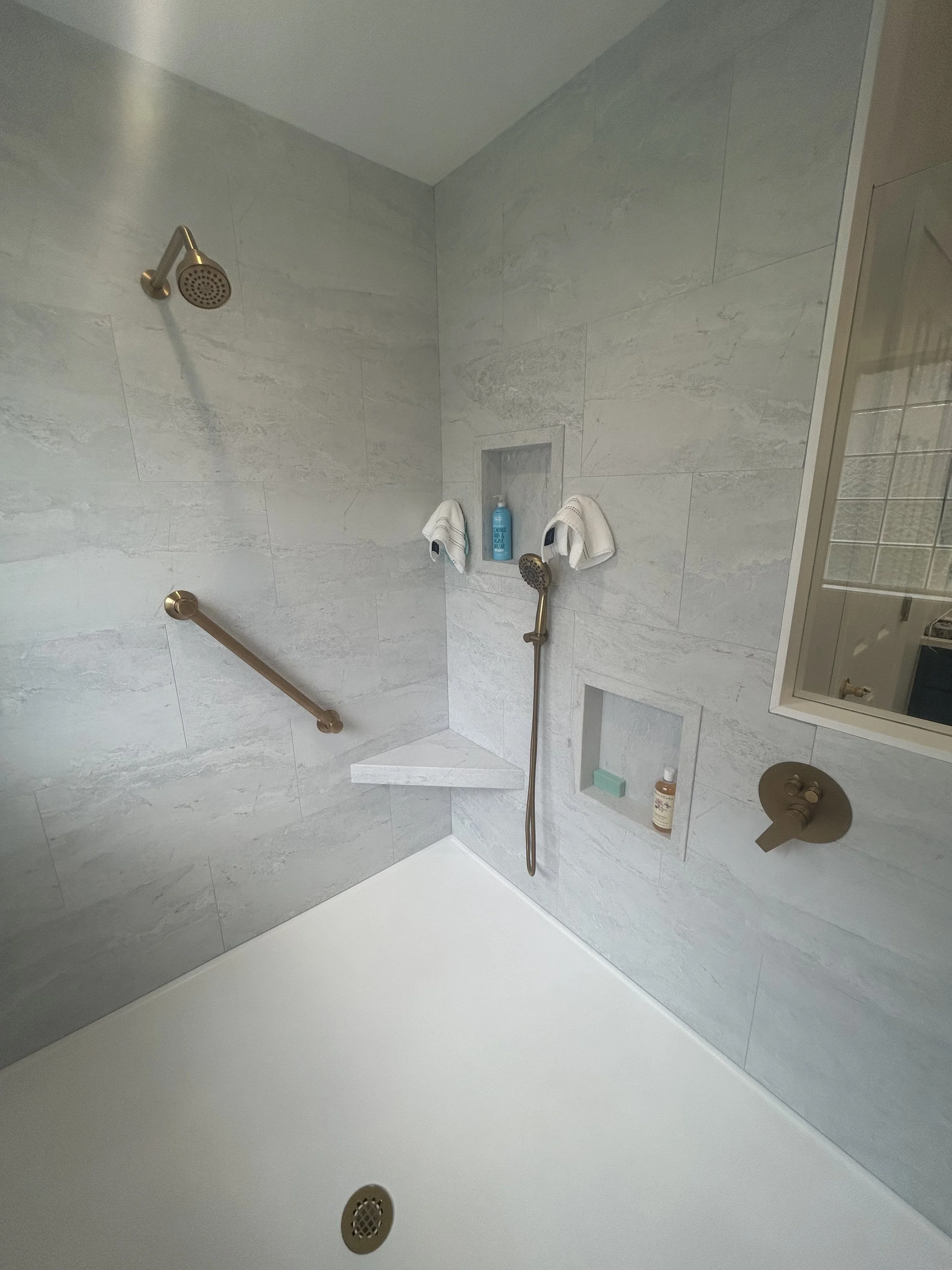This is "Polar Frost" wall tile with a matching corner bench and recessed niches.