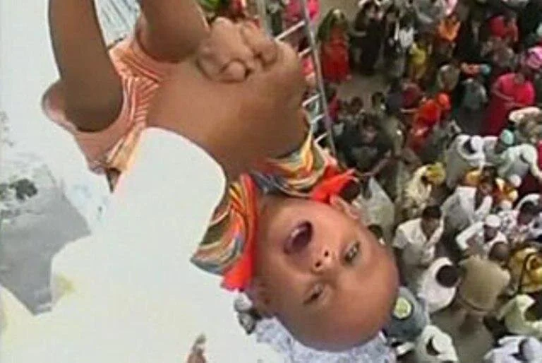 For Babies in India, a 30-Foot Plunge for Good Luck
