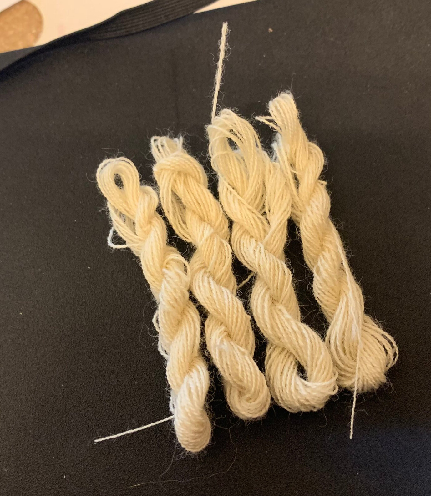 four small skeins of sewing thread