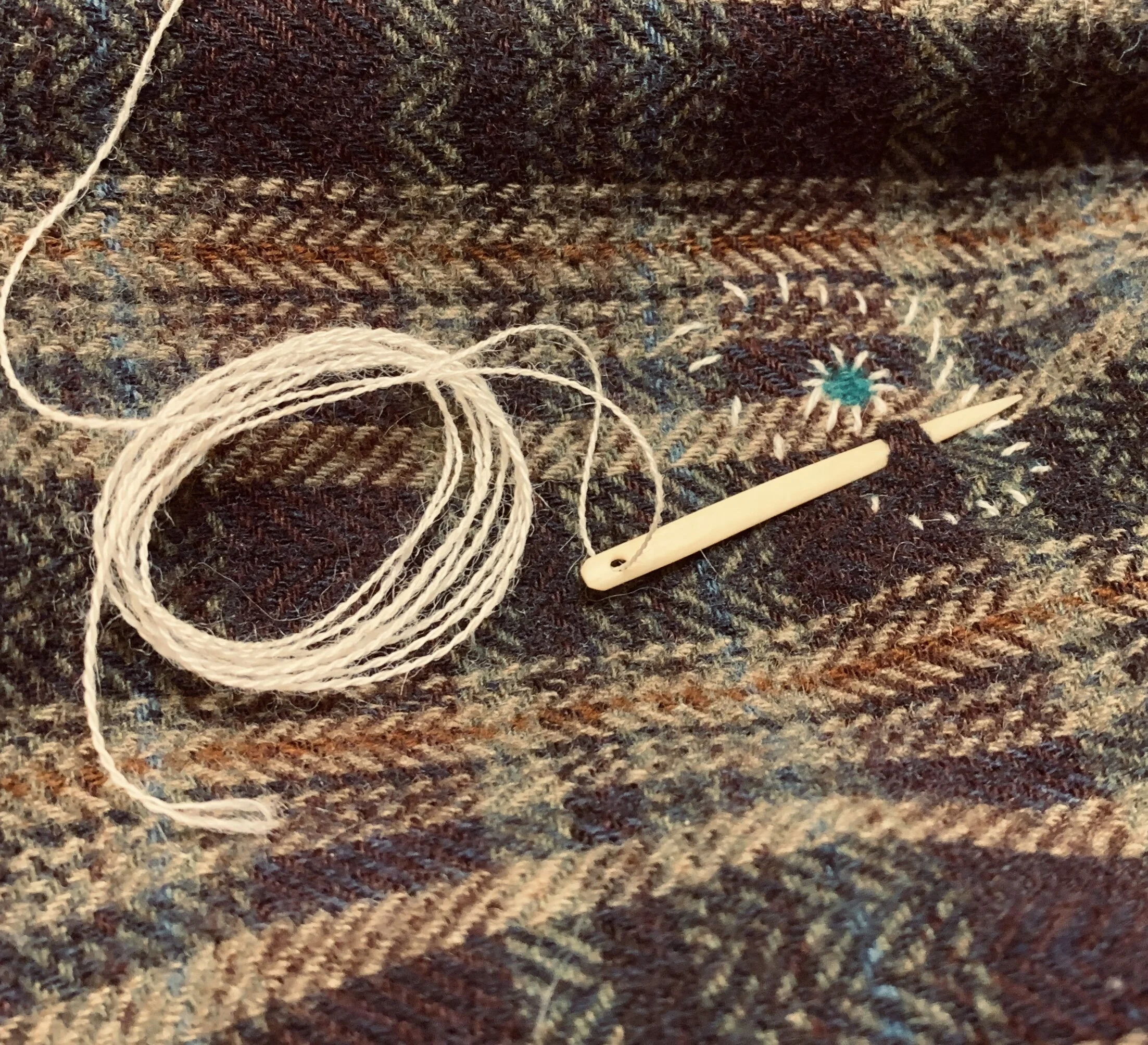 it was really interesting trying to sew with a bone needle, but i liked it.