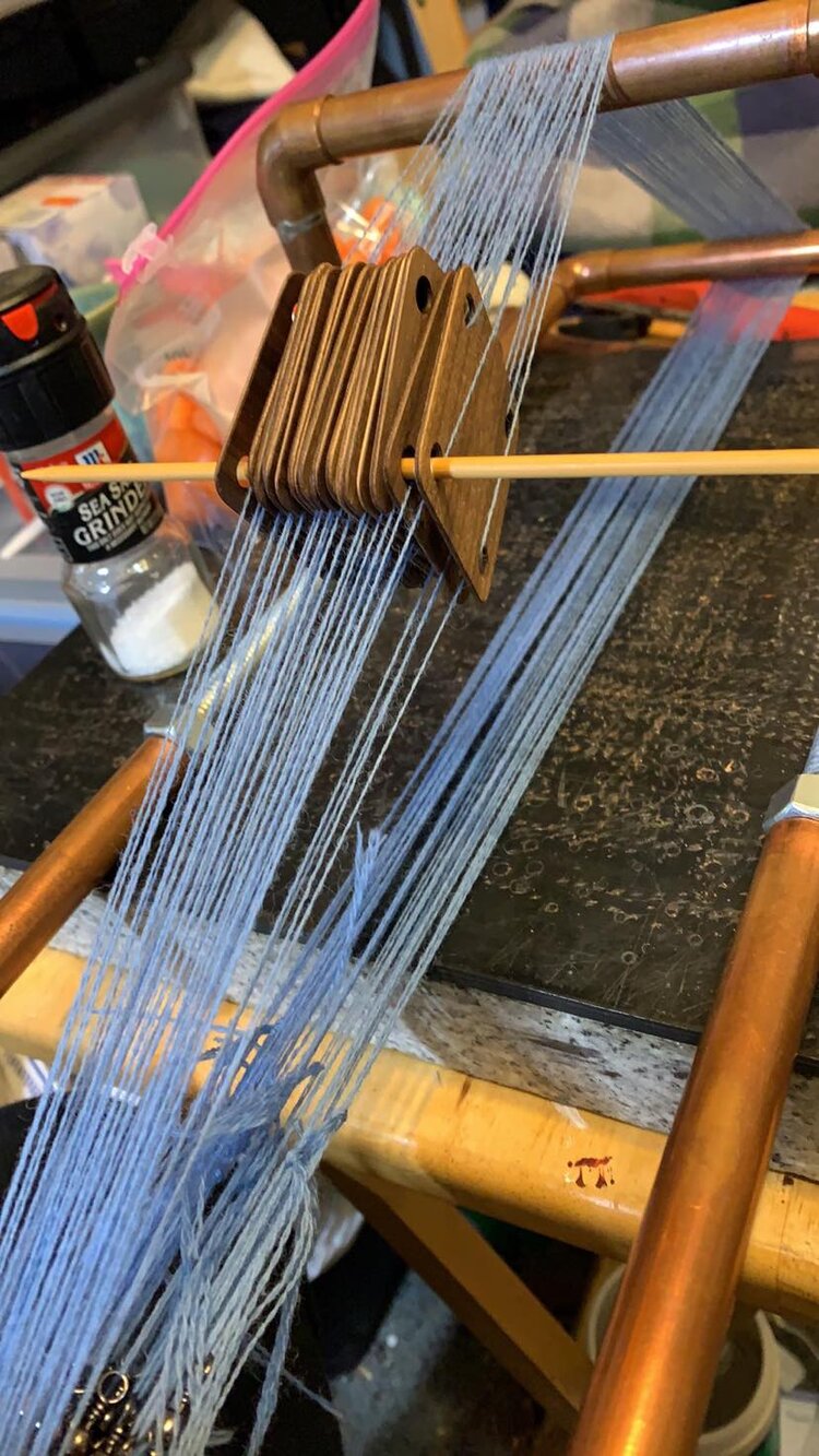 after warping, I held all the cards in place with a knitting needle. I used another knitting needle to pick up threads to make passing the brocade weft easier.