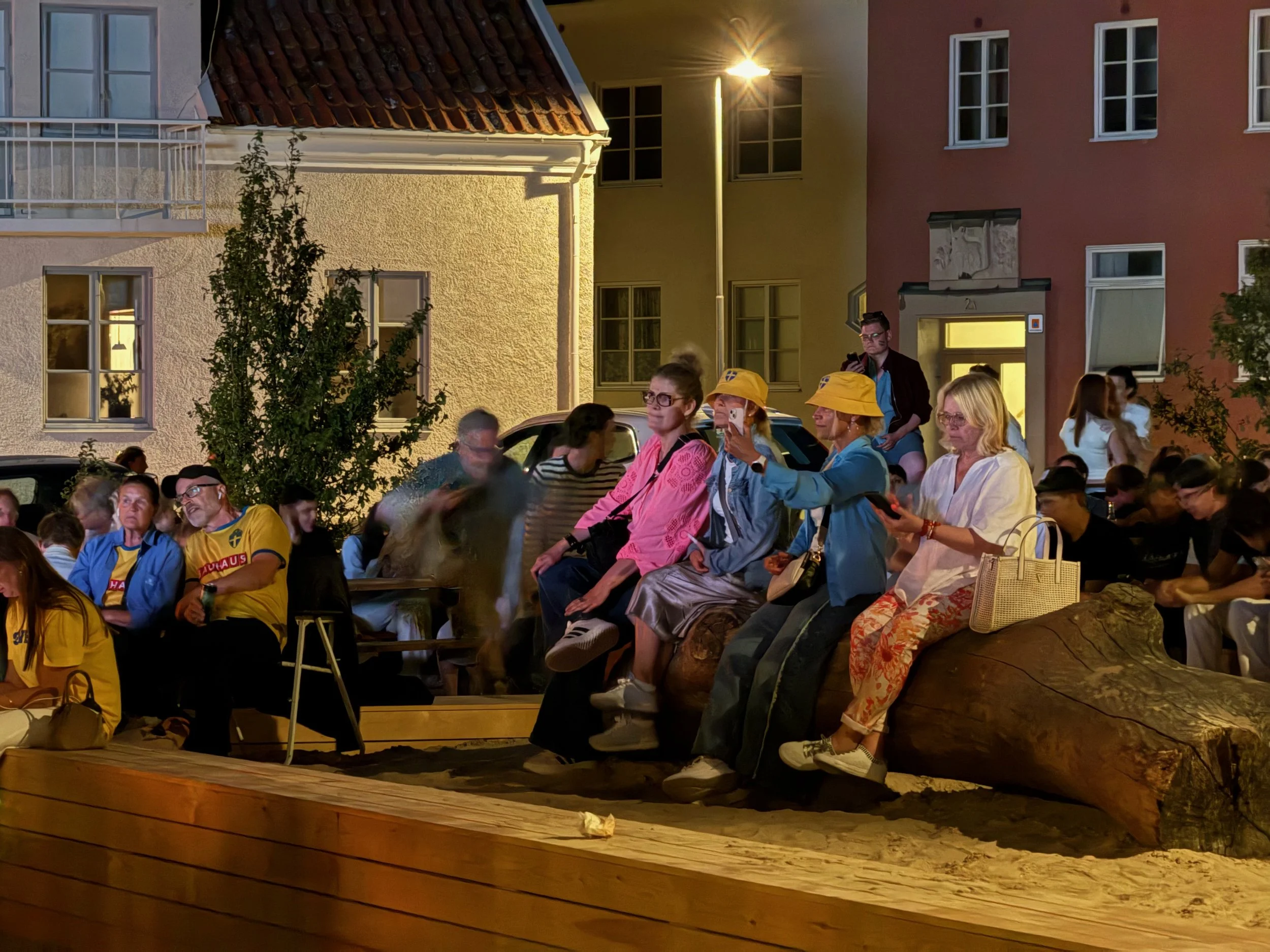People using the oak logs as seating during game time