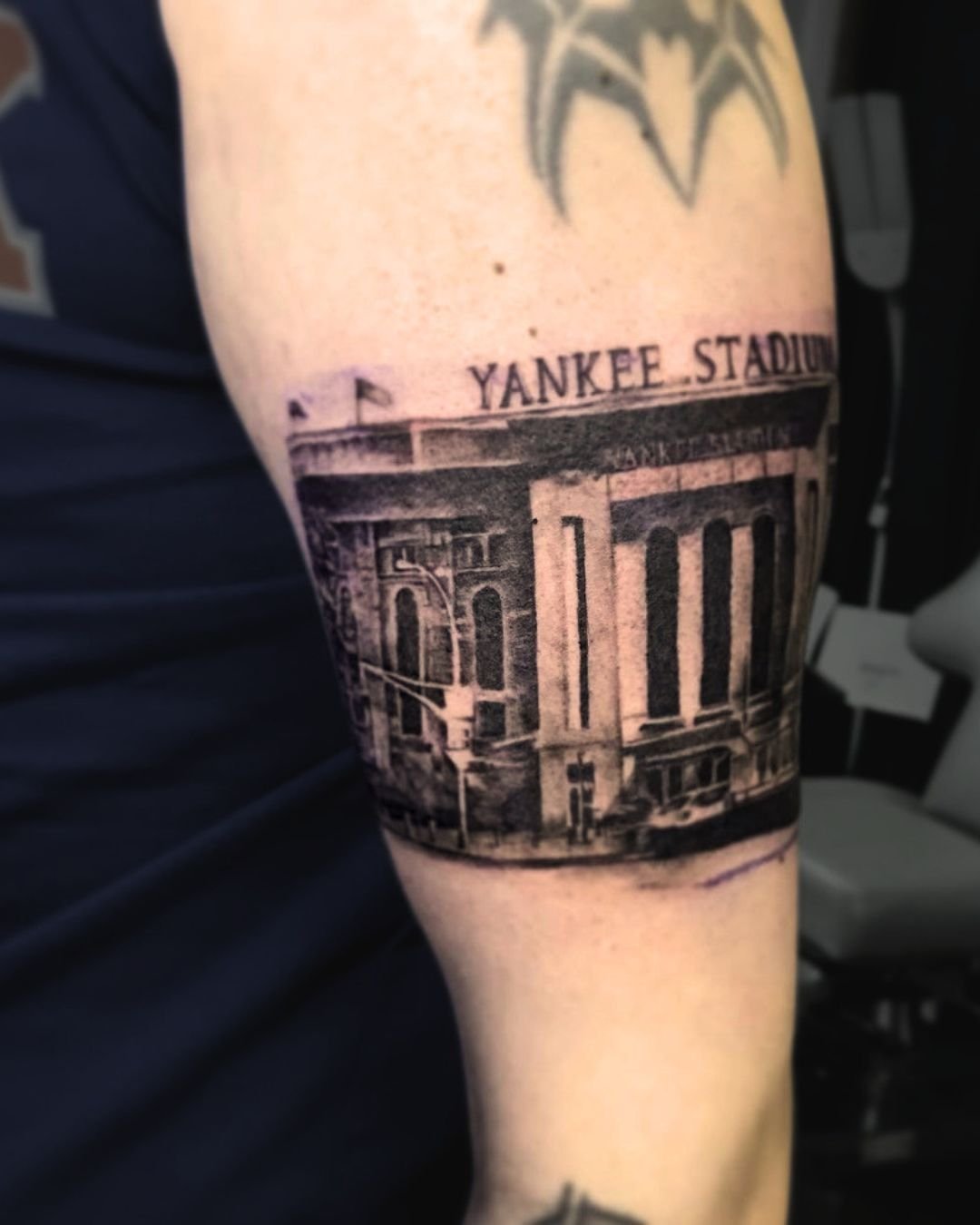 Black and grey realistic Yankee Stadium tattoo on calf by Brass Knuckles Ink Tattoo Studio in the Bronx