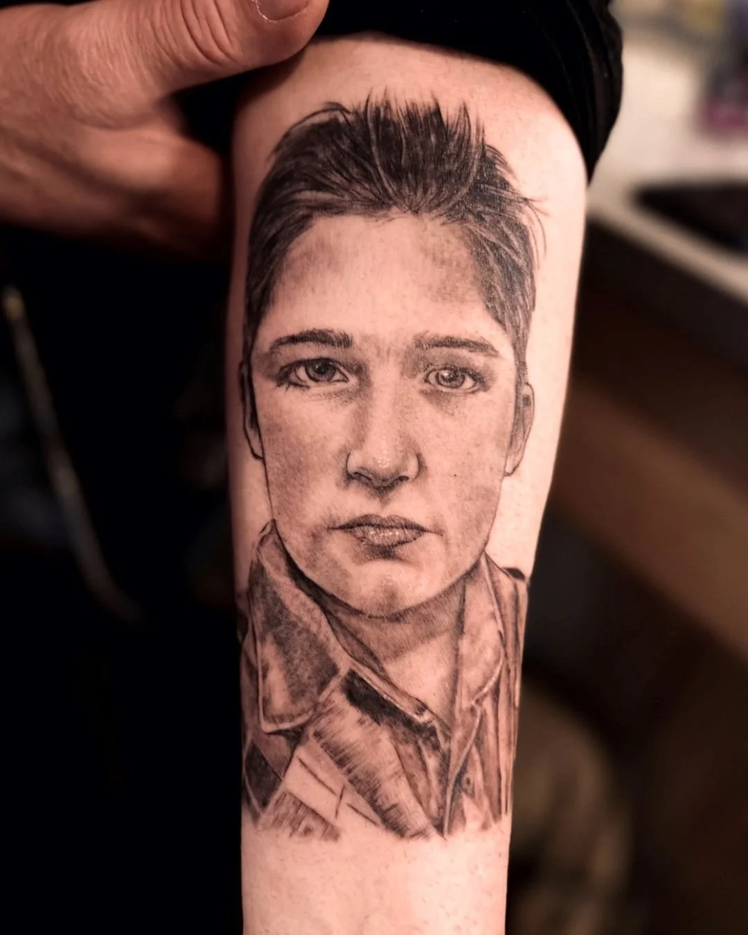 This memorial portrait tattoo was created to honor the life and memory of a beloved son. Rendered in realistic black and grey with soft transitions and careful attention to expression, the piece reflects both technical precision
