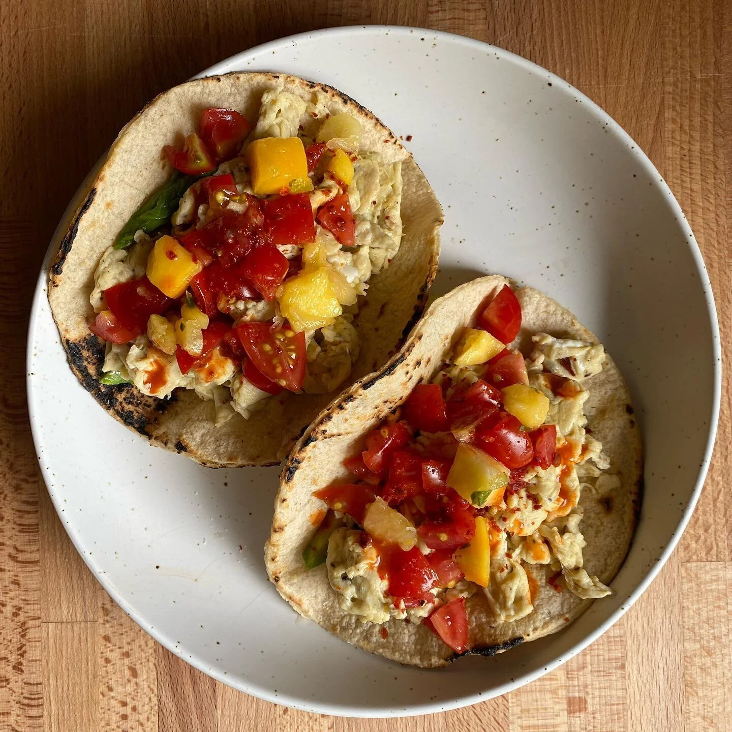 Late Summer Breakfast Tacos 

&mdash; corn tortillas 
&mdash; 1 egg + 1 egg white
&mdash; avocado 
&mdash; garden grape tomatoes
&mdash; pineapple 
&mdash; mango 
&mdash; dried aleppo pepper
&mdash; homemade habanero hot sauce
&mdash; lime