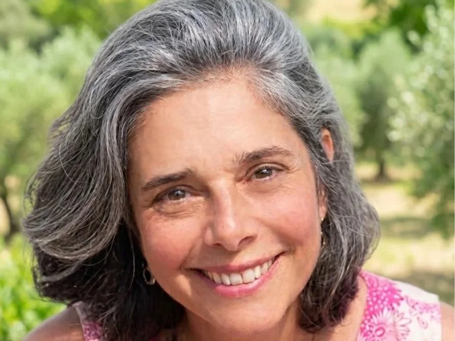 Headshot of a woman with a natural outdoor setting