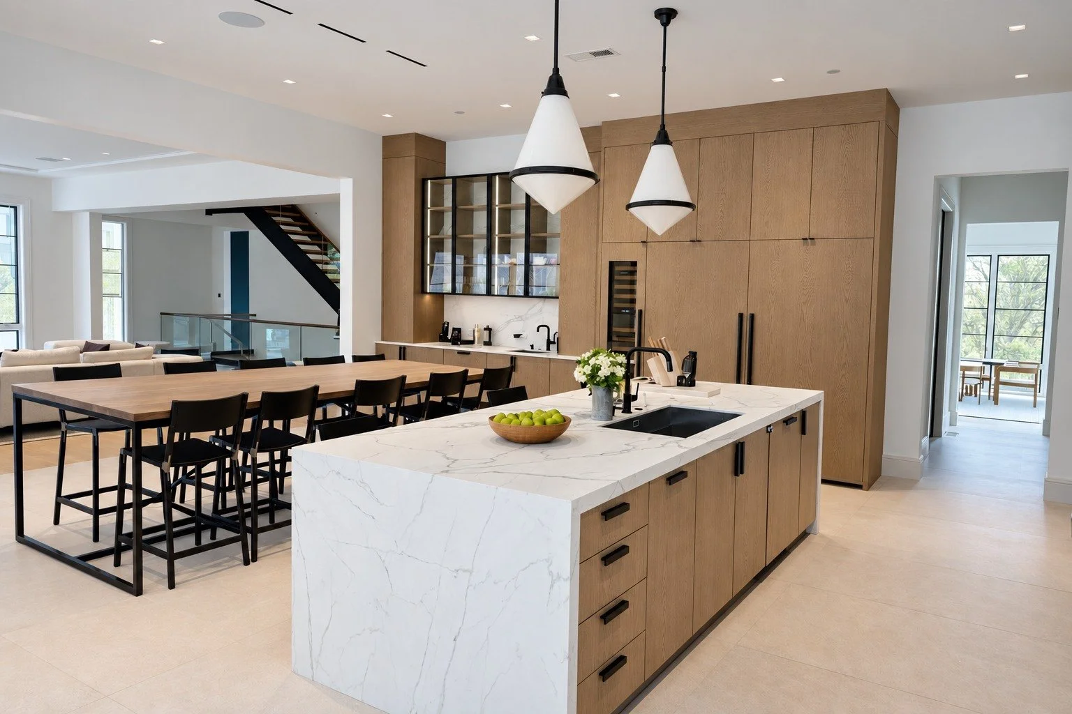Custom oak cabinetry, a waterfall stone island and carefully coordinated lighting.