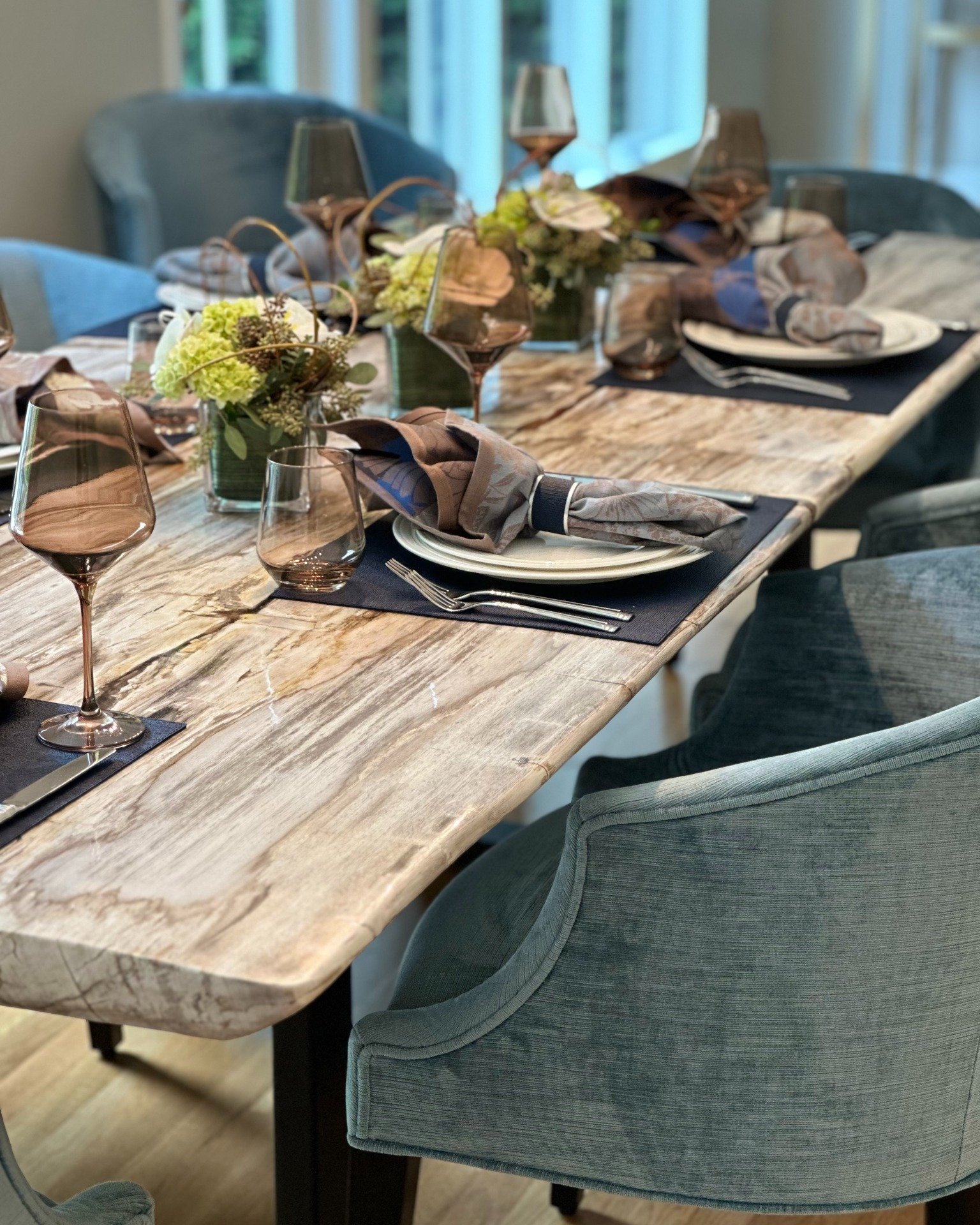 It was a real pleasure to work on this project and with such wonderful clients!  The dining room is the perfect combination of unique textures (petrified wood, steel, and vintage-feel velvet) with the client's own personality and level of sophisticat