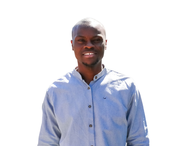 Portrait of a smiling Black man in a light blue button-up shirt outdoors.