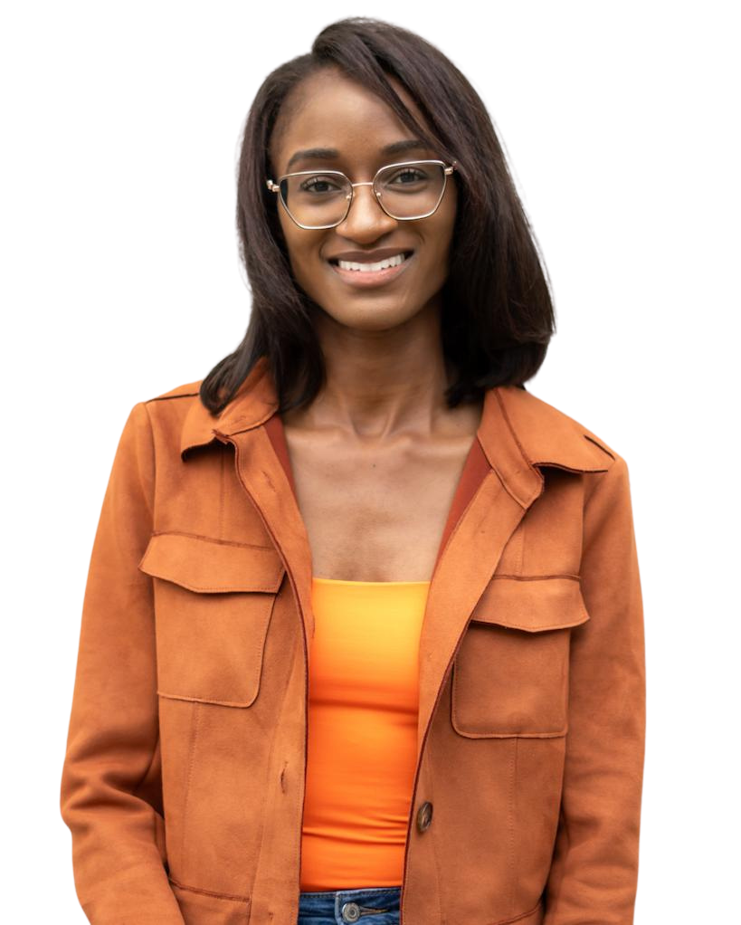 A smiling Black woman with glasses, wearing an orange jacket over a yellow-orange top.