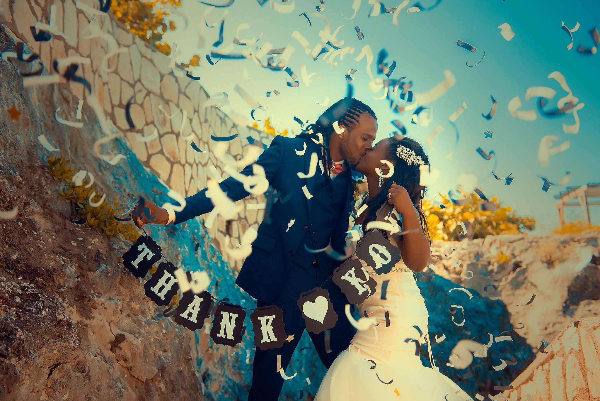 bride and groom kissing with confetti , negril jamaica