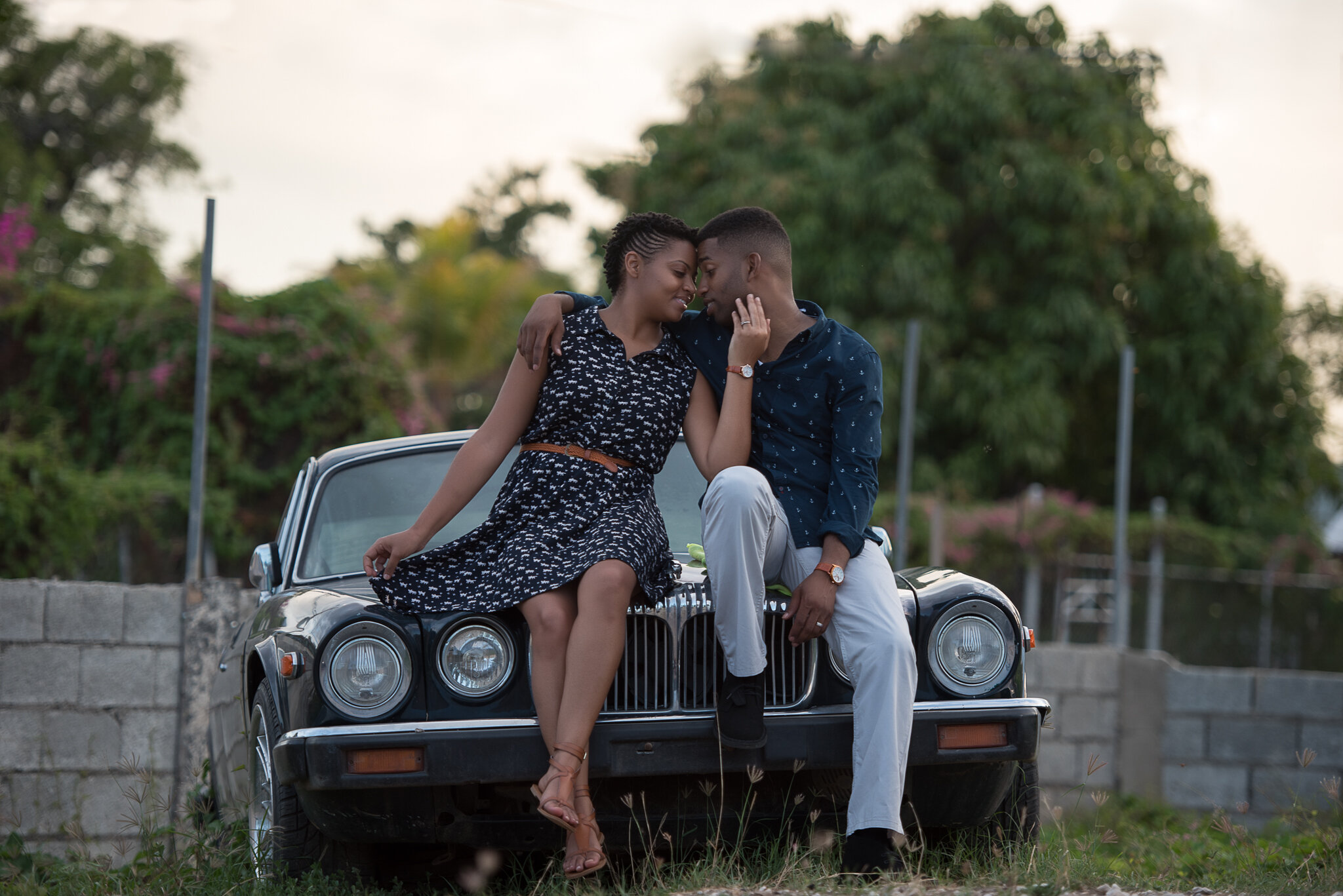 bride and groom kissing on vintage jaguar car