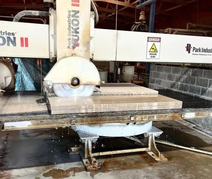 Fabricator visit with client to review custom 24-inch limestone coping in production and finalize eased-edge selection.