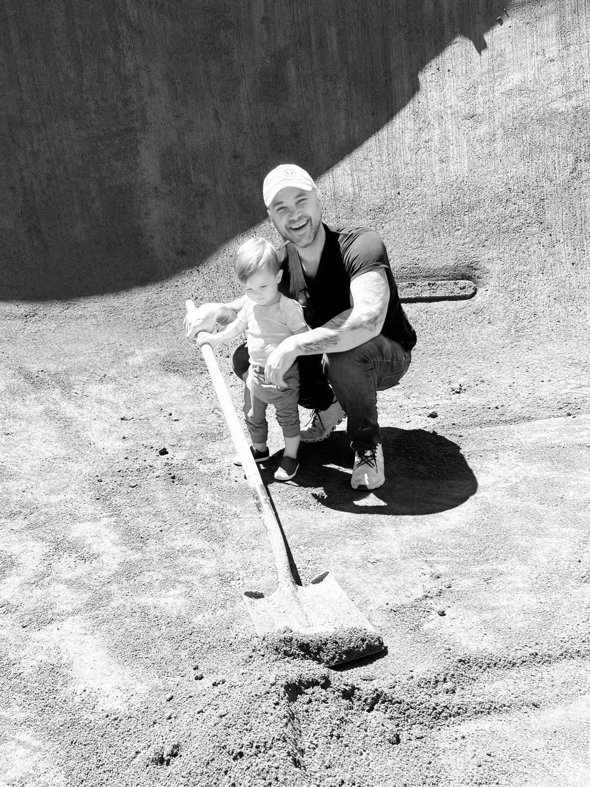 Gabriel Messuti with his son inside a gunite pool under construction, illustrating generational craft and discipline