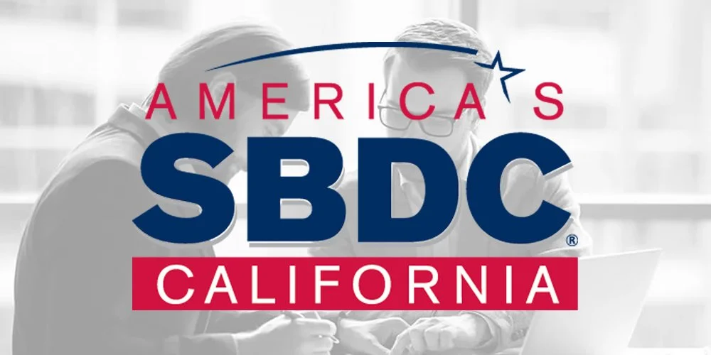 Logo of America’s SBDC California with two people discussing over a laptop in the background.