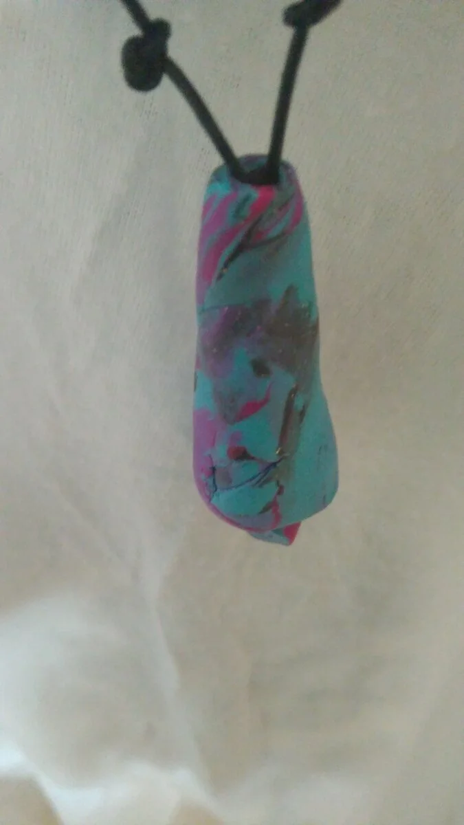 Such an unusual necklace. Made from Polymer Clay in layers creating a liquorice look. Threaded with a strong black jewellery thread. Measurements: 50 cm in length from nape of neck.