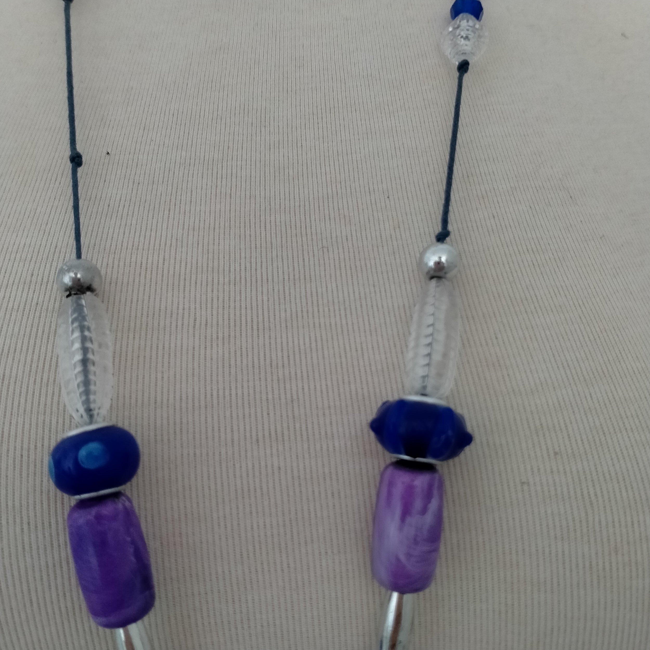 A beautiful crafted necklace. Made using crystal, rondelles, glass, resin, acrylic and metal beading in lilac and navy blue beading.