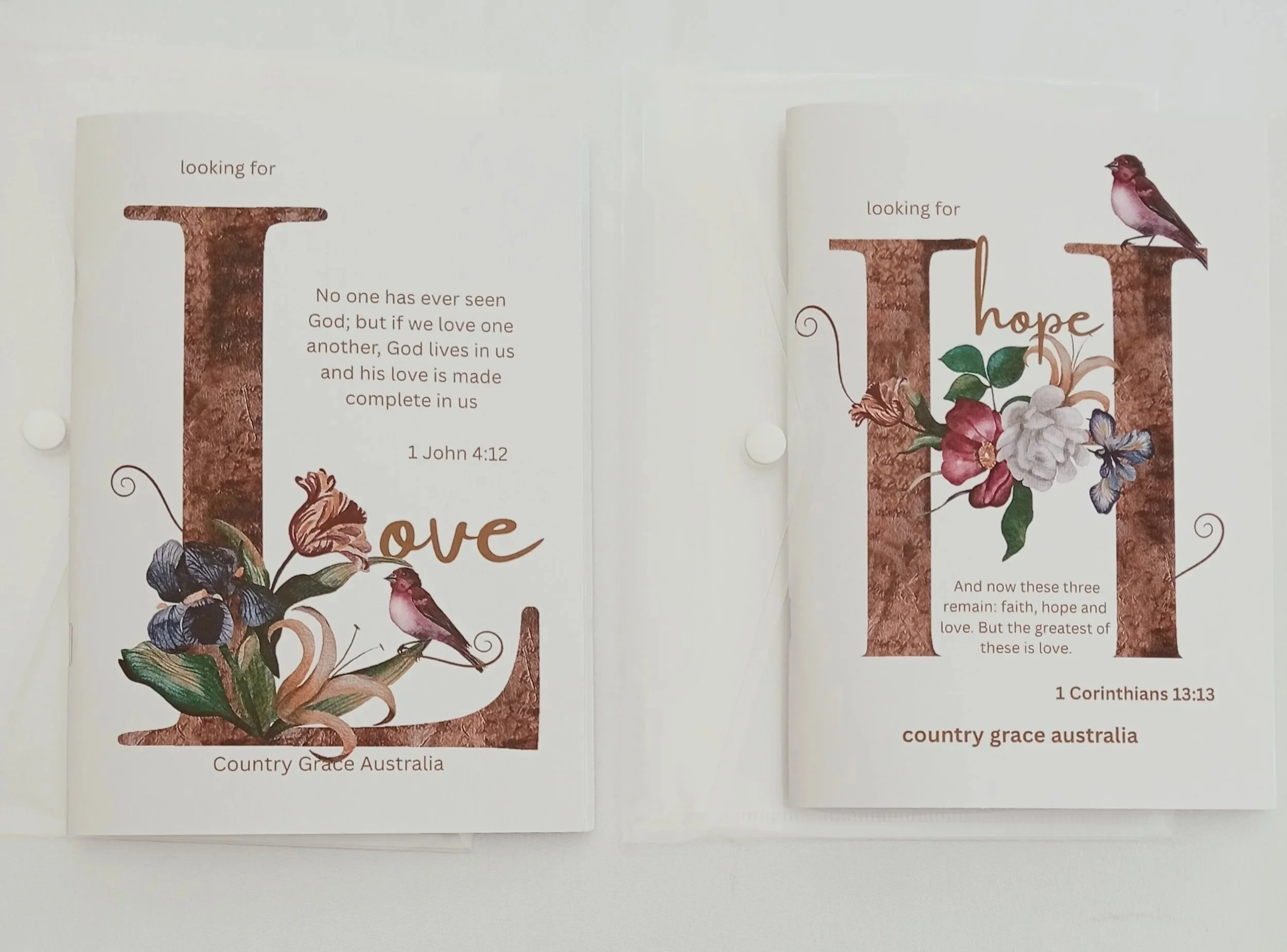 Open book with faith, hope, and love verses, decorated with flowers and birds, from Country Grace Australia.