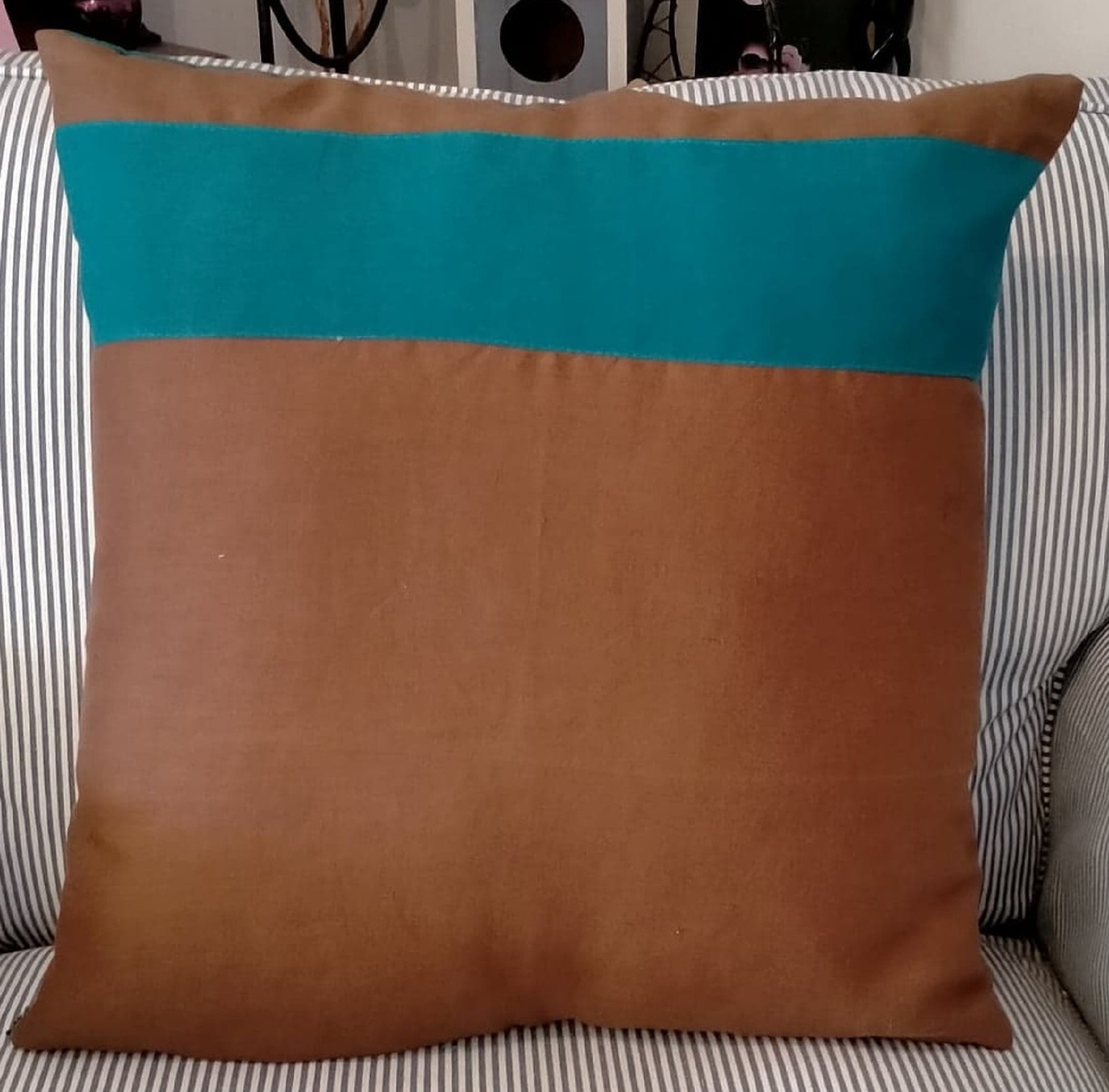 Love love love linen and cotton. Linen is a strong and textured fabric and when it is combined with cotton it has a little bit of a softer feel about it. The front of this cushion has a Teal Panel.