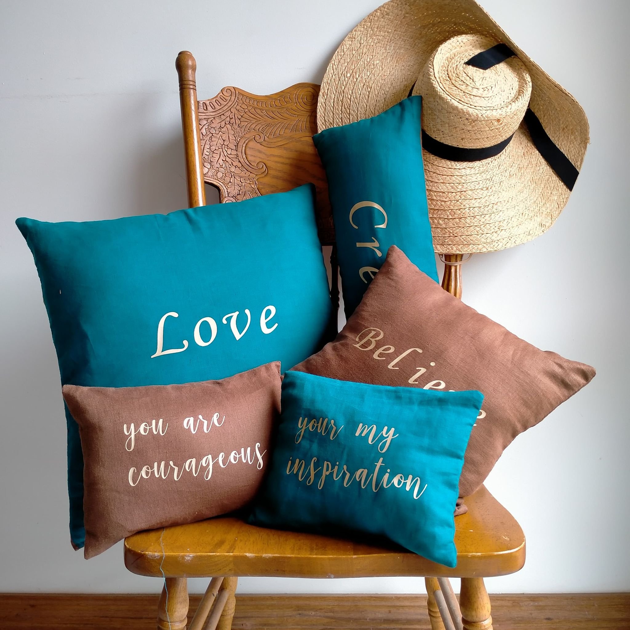 Linen is a strong and textured fabric and when it is combined with cotton it has a little bit of a softer feel about it. The front of this cushion is in Teal and has the word Create on it.