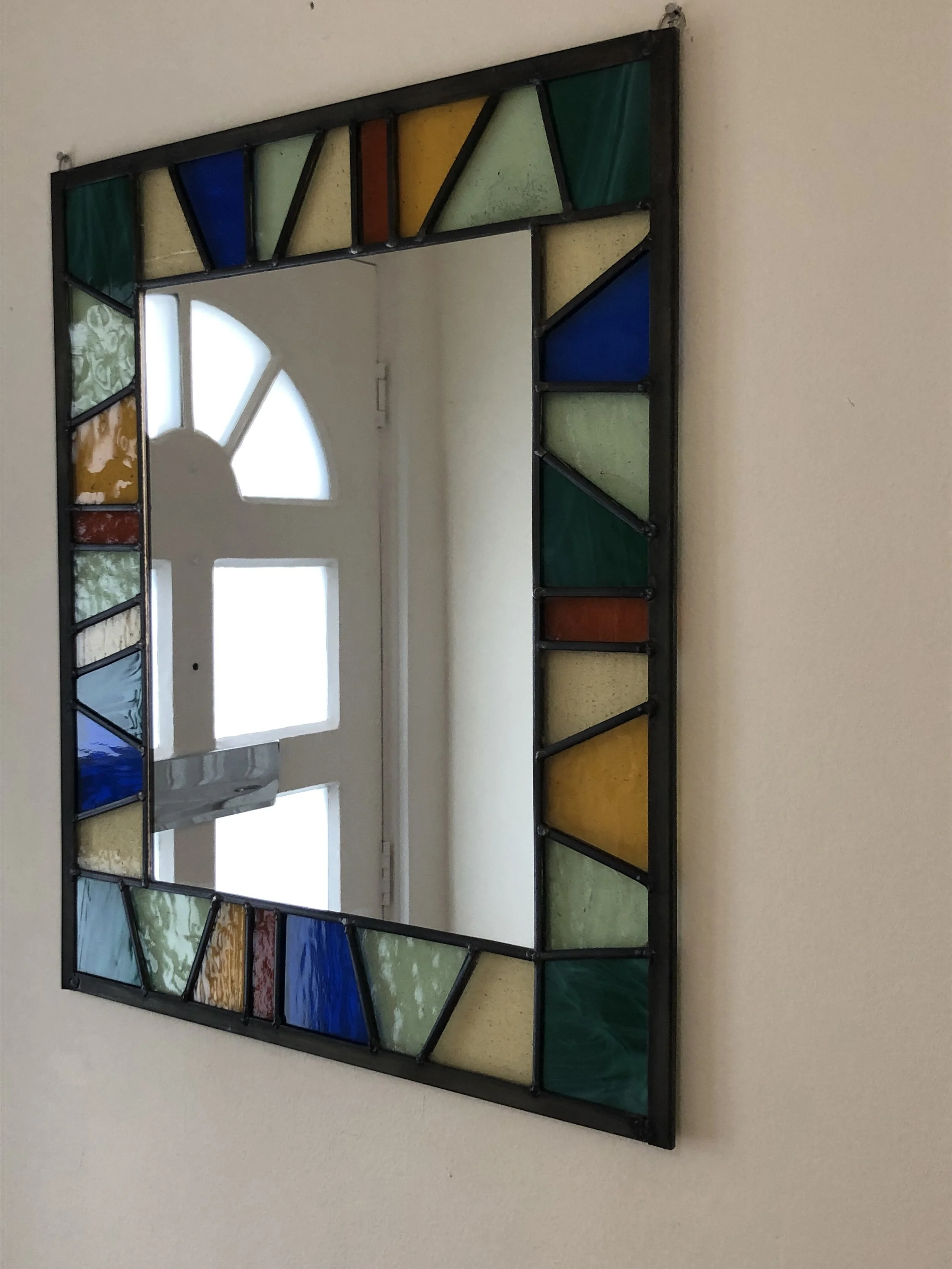  Large mirror using geometric shapes in colours to compliment the room’s decor. Selection of hand-cut textured glass.  