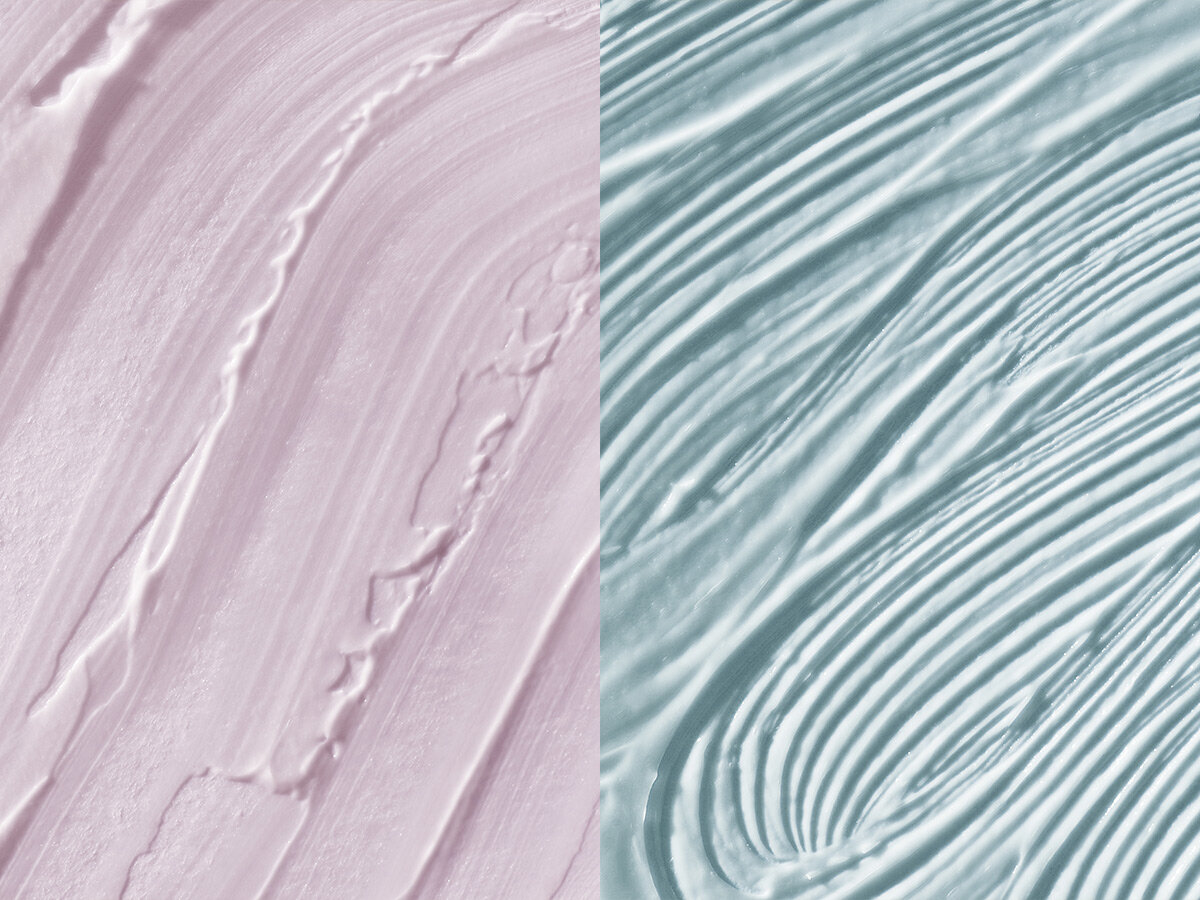 Close-up of two textured paint strokes, one in pink and the other in blue, with visible brush marks and ridges.
