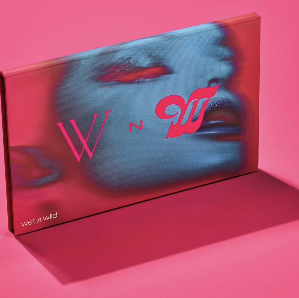 A colorful box with a stylized image of a woman's face and lips, featuring the words 'wet n wild' and 'W N W' on a pink background.