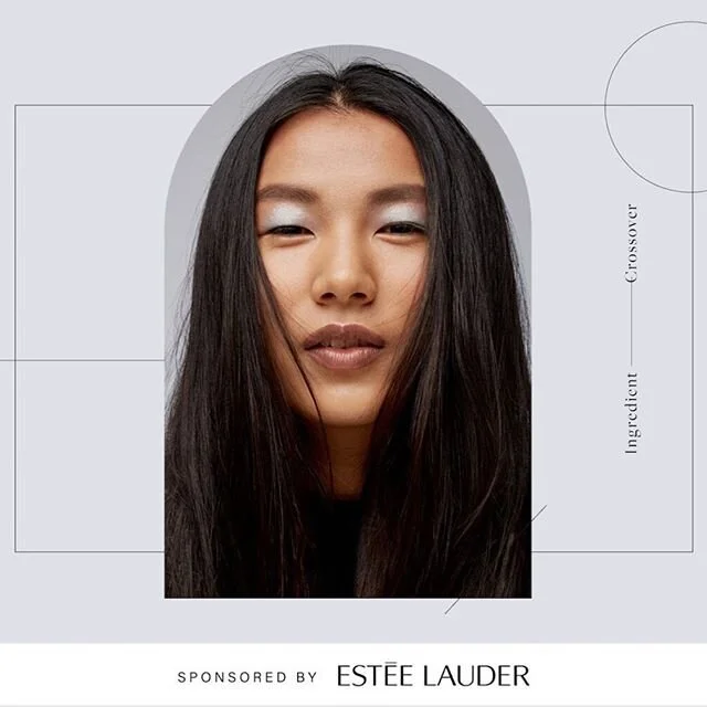 Close-up of a woman with long dark hair, one eye winking, in a promotional fashion ad for Estee Lauder.