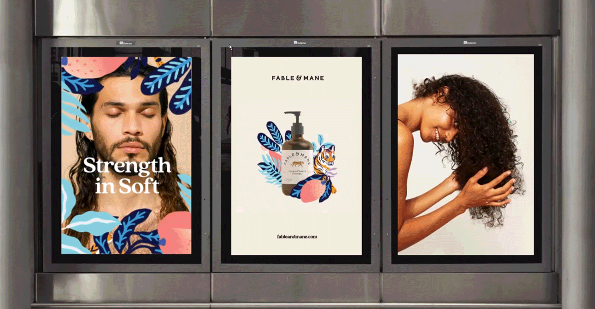 Three posters in a row on a metal surface, featuring a man with long hair and a woman with curly hair, with the middle poster displaying a bottle of hand soap with decorative leaves and a tiger illustration.