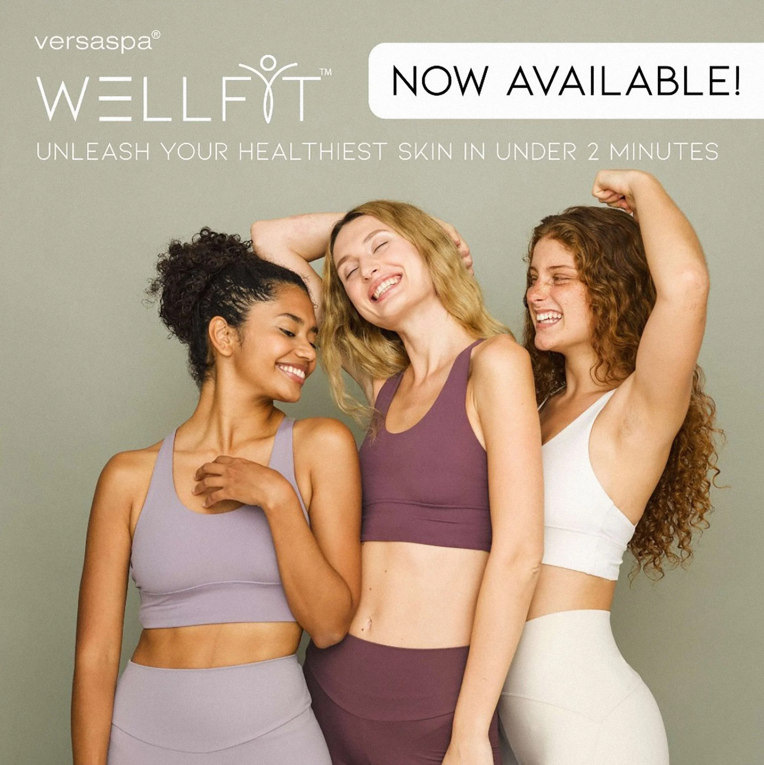 Group of women wearing sports bras, smiling, and embracing each other, with a light green background. Text advertising wellness spa products, stating 'Wellfit™ now available! Unleash your healthiest skin in under 2 minutes.'