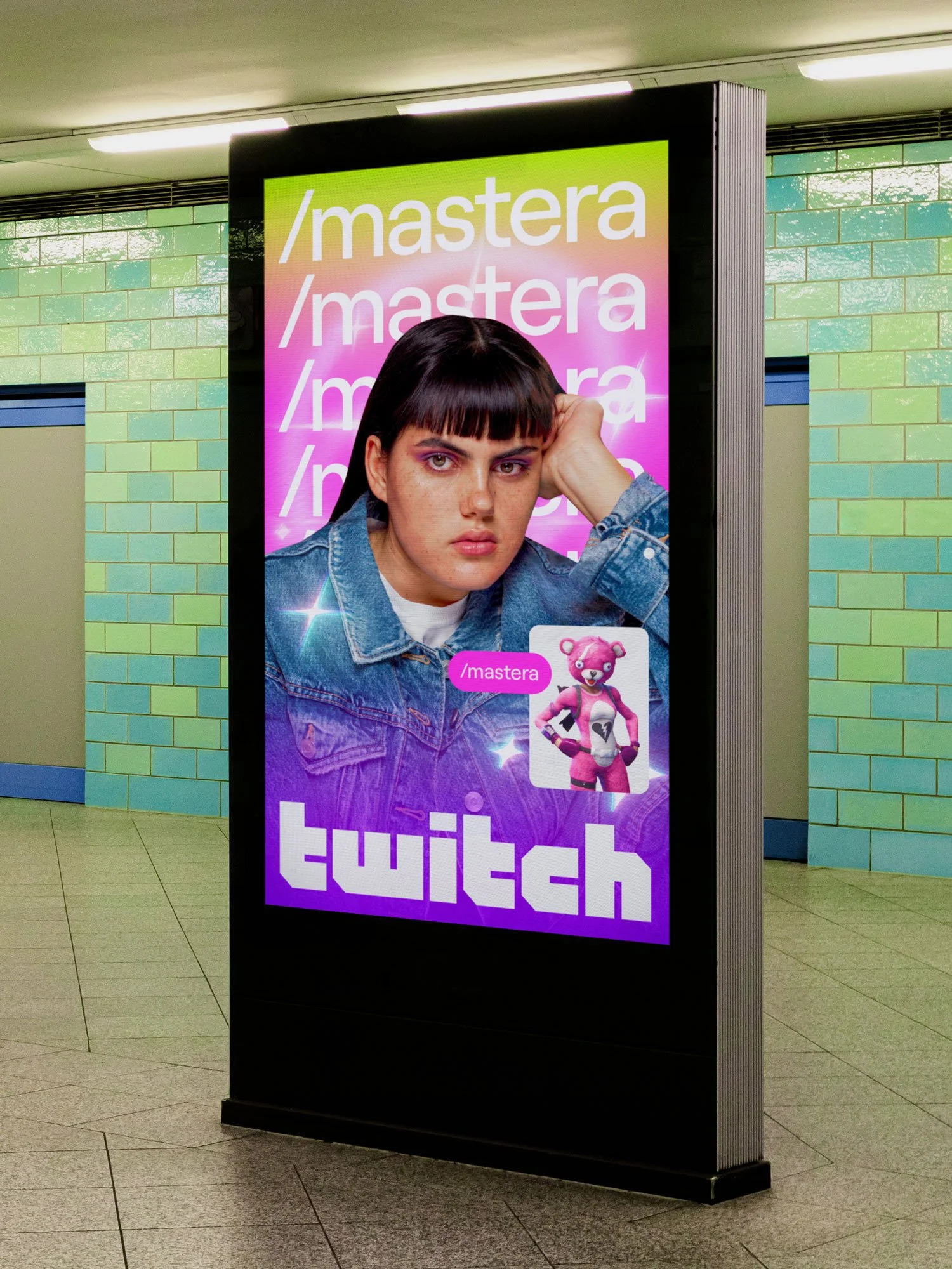 Digital signage in a public transit station displaying an advertisement for Twitch with a photo of a young woman with dark hair and bangs, wearing a denim jacket, and some animated pink and purple mascots.