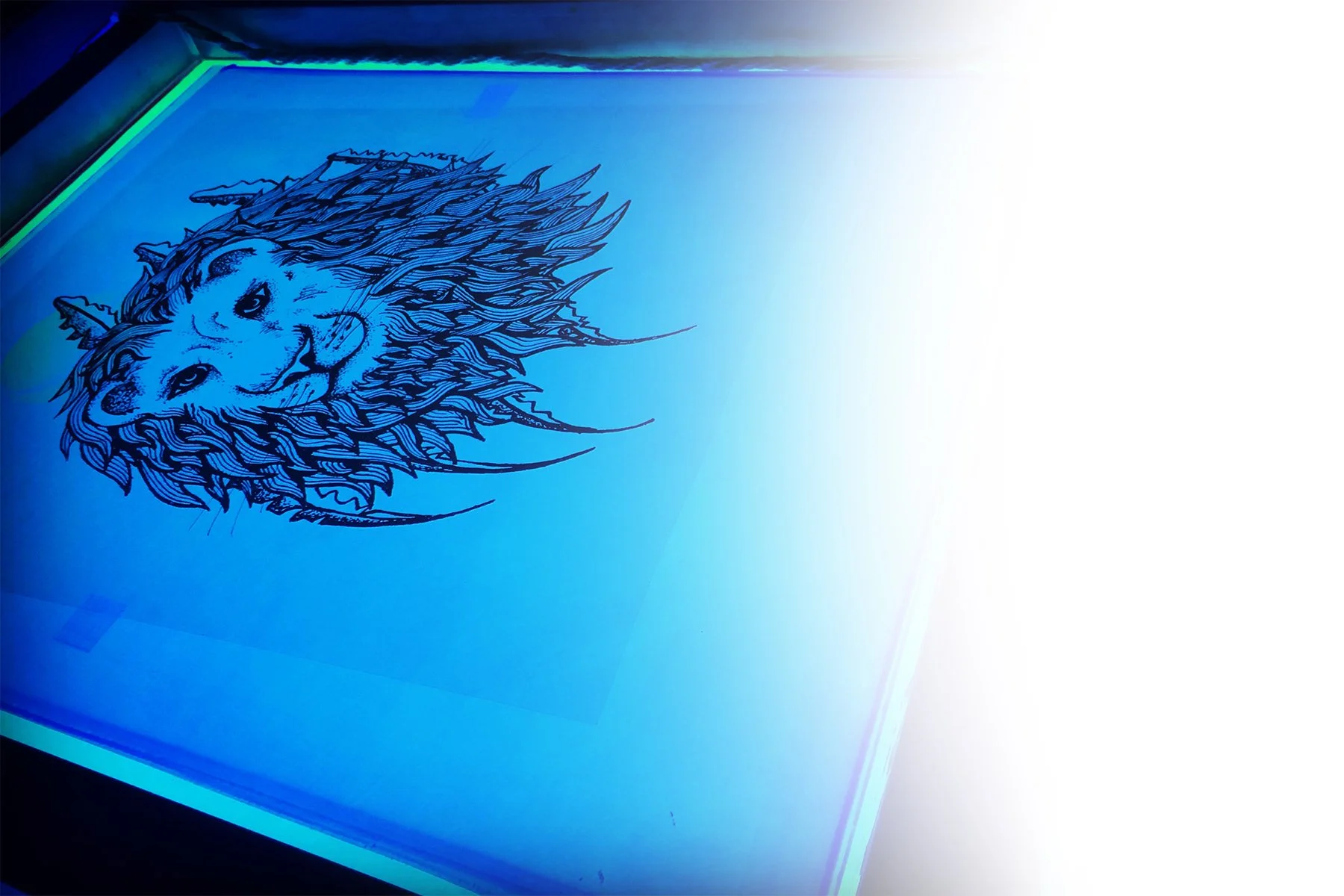 A stylized lion's head graphic on a light blue illuminated surface, possibly a digital screen or glowing panel.