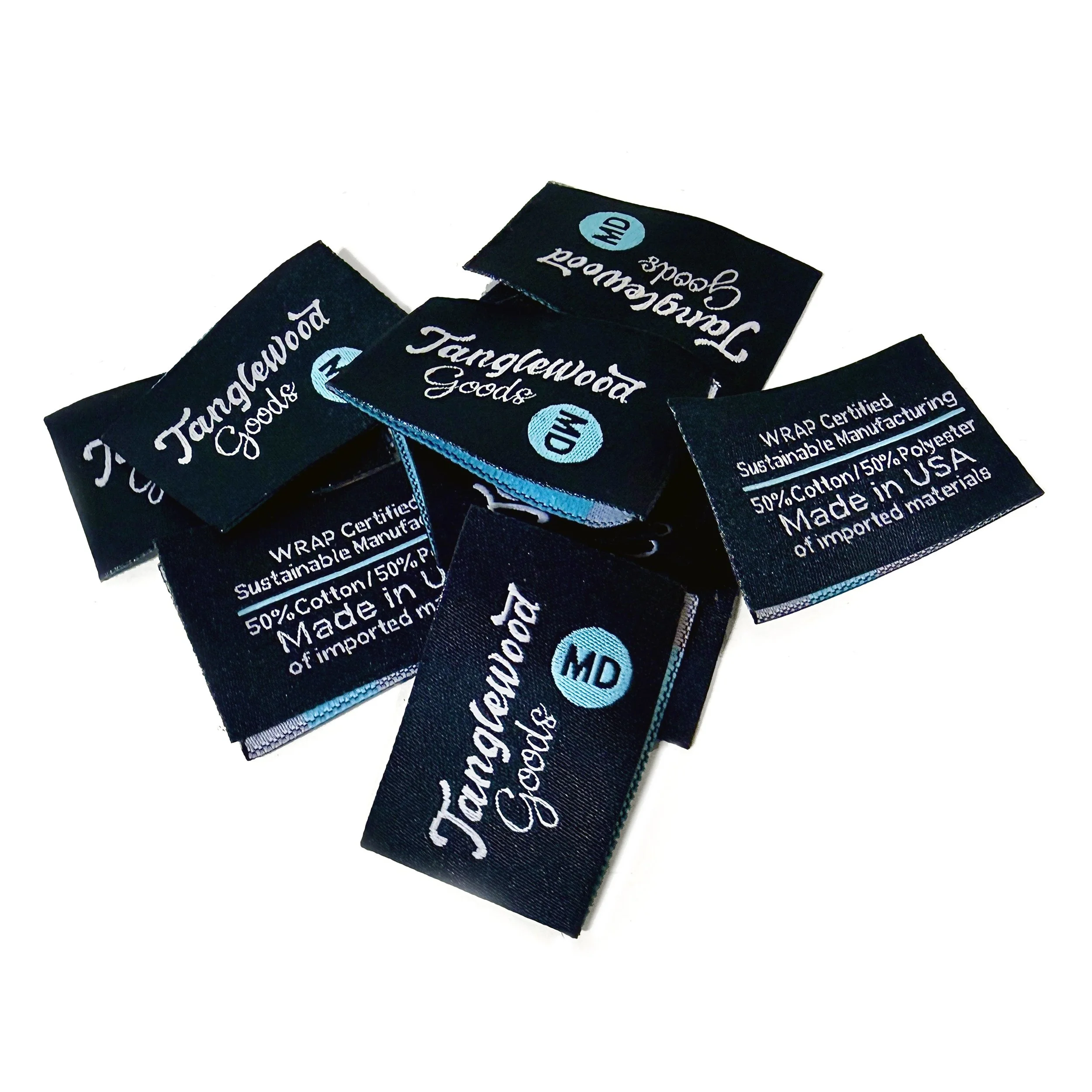 Several black tags with blue and white text reading "Tanglewood Goods."