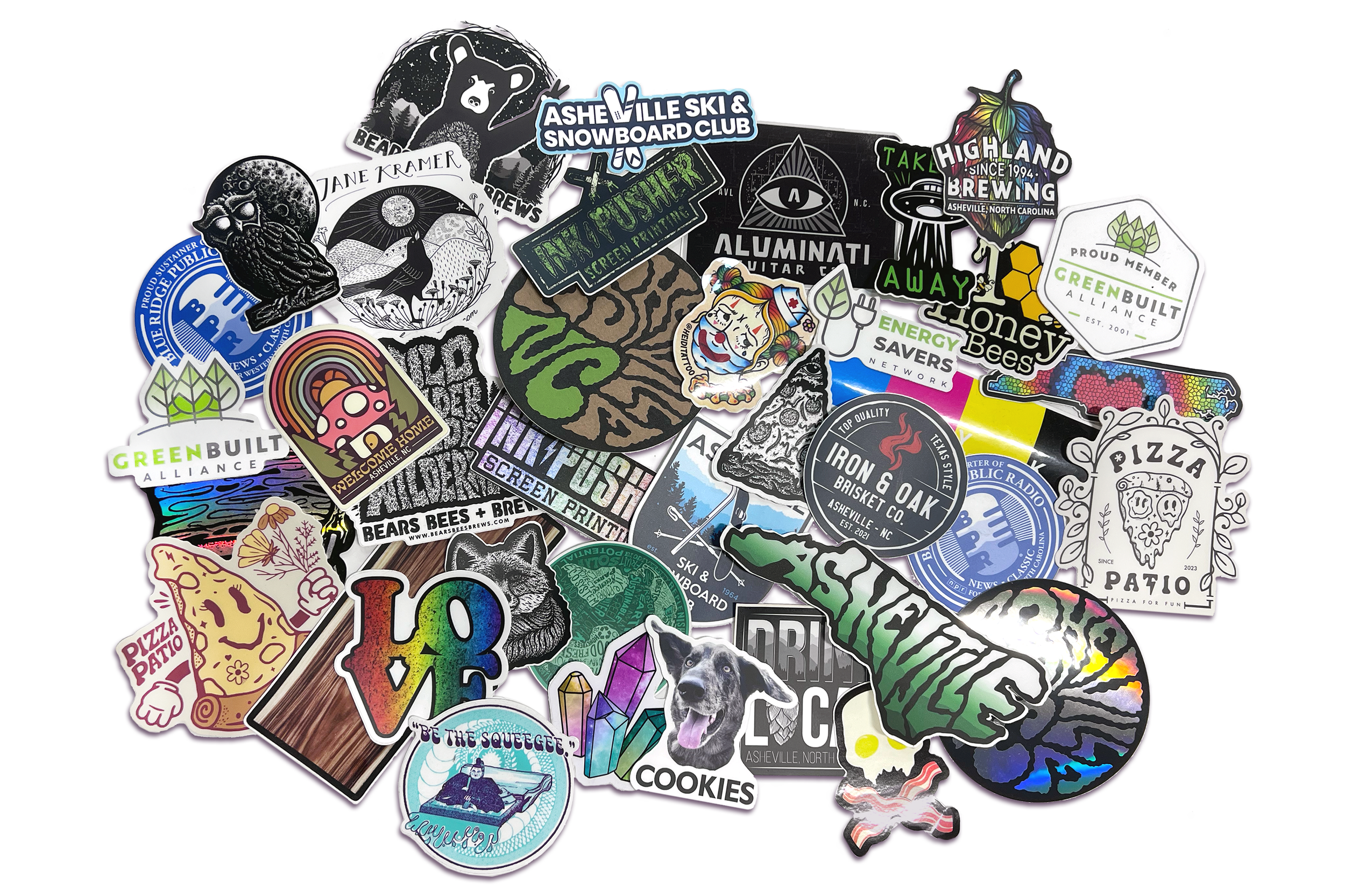 A collection of colorful and black-and-white stickers featuring various designs, logos, and artwork, including nature scenes, animals, abstract patterns, and local businesses.