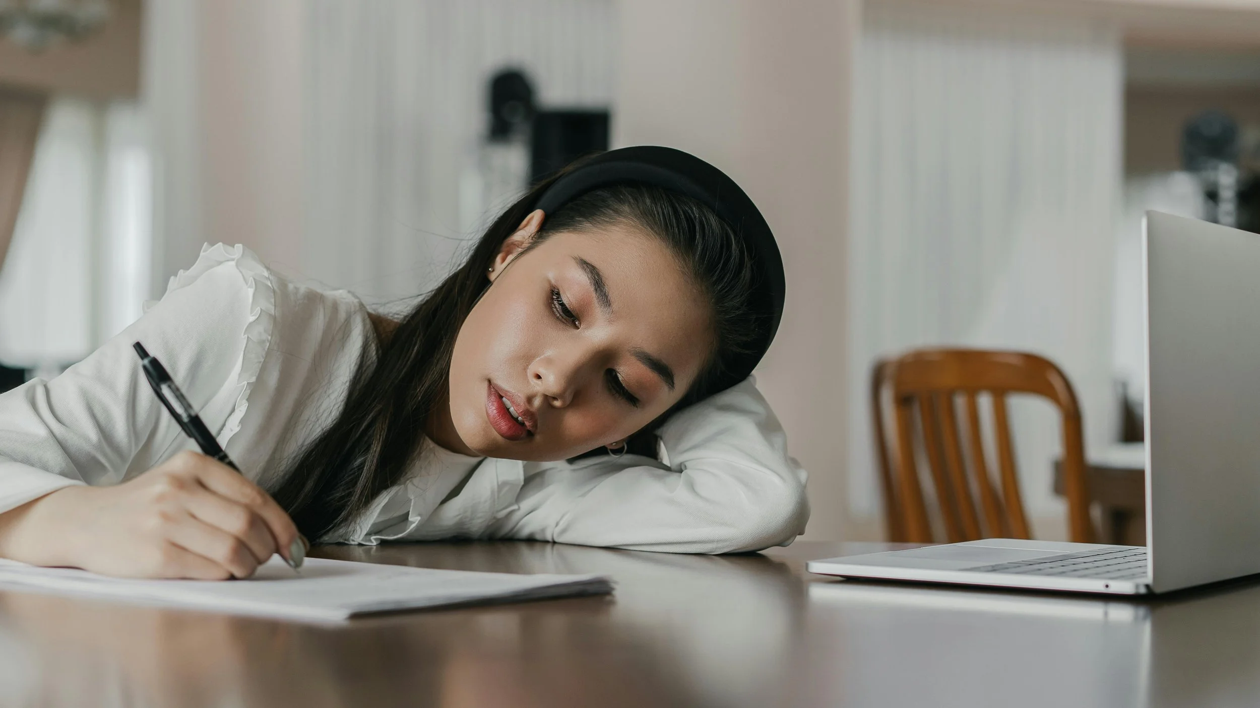 Girl laying on arm and writing