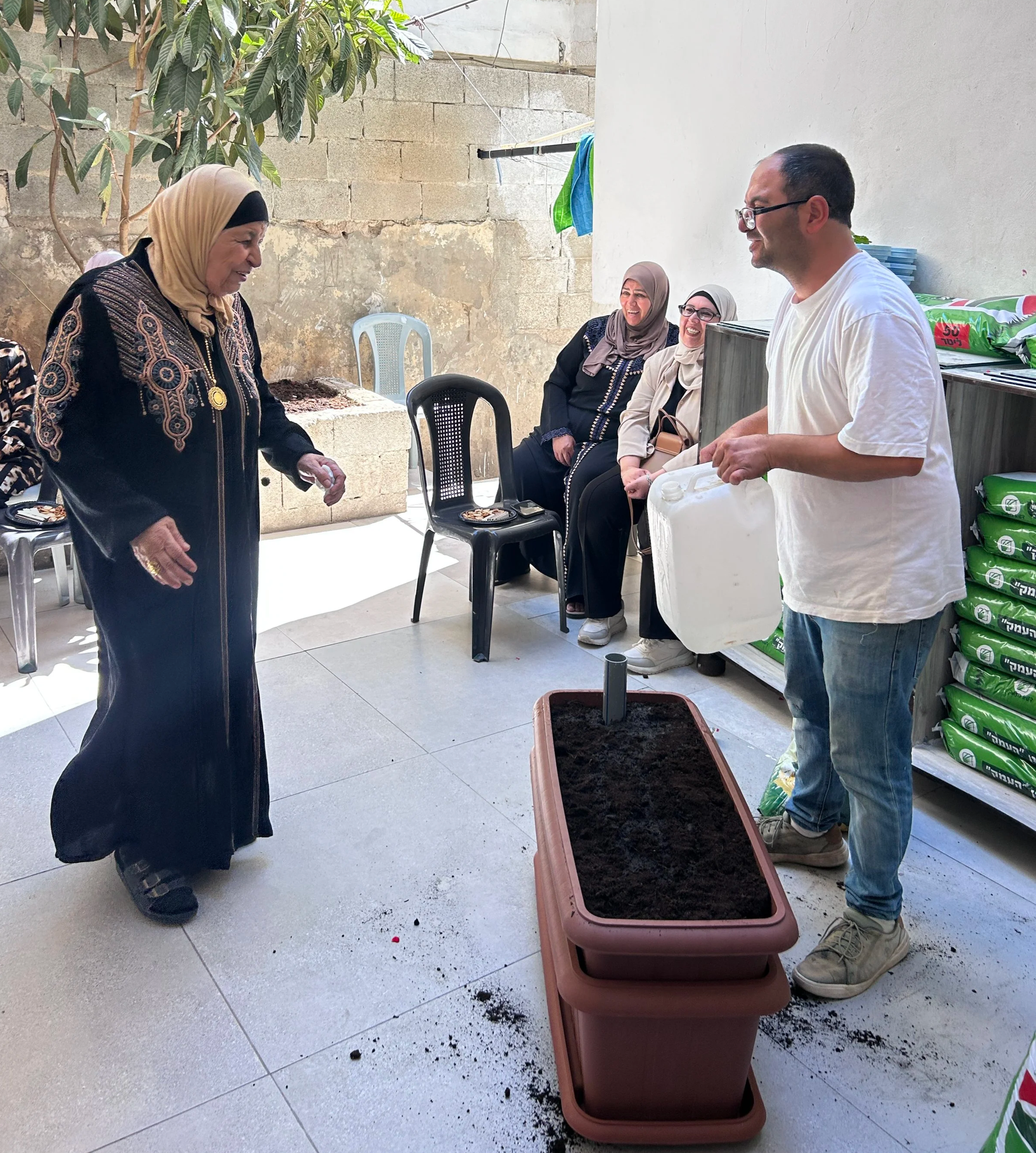 Planters for the rooftop gardens being distributed to 35 families by the food program director.