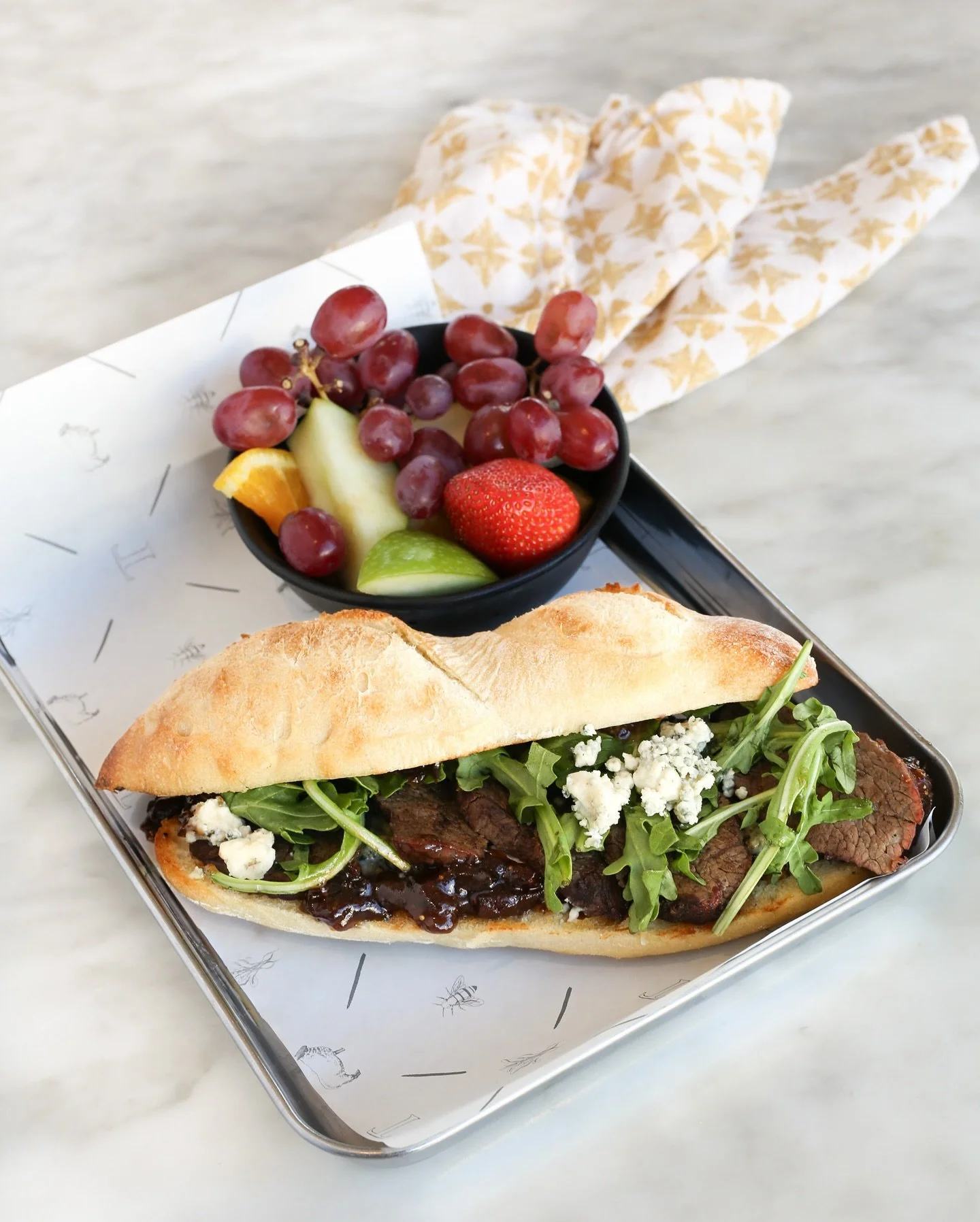 Have you heard our Fall / Winter menu is out?! A favorite is back and better than ever, our 𝗦𝘁𝗲𝗮𝗸 &amp; 𝗕𝗹𝘂𝗲 𝗙𝗶𝗴! Thin-sliced steak, fig-balsamic onion jam, blue cheese crumbles, and fresh arugula&mdash;all tucked inside a warm baguette (