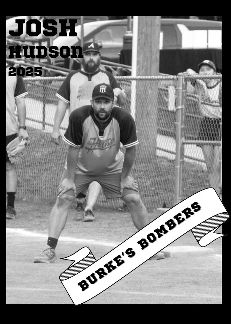 Black and white photo of a man in a baseball uniform and cap crouching in a ready stance on a baseball field. Behind him are two other boys, one standing and one sitting by a fence, with trucks in the background. There is text overlay reading "JOSH HUDSON 2025" in the upper left corner and a banner at the bottom with the text "BURKE'S BOMBERS."