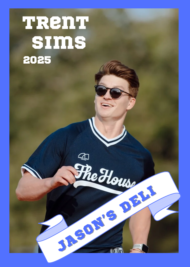 A young man in sunglasses and a navy blue sports jersey with white lettering and trim, smiling while running outdoors with trees in the background.