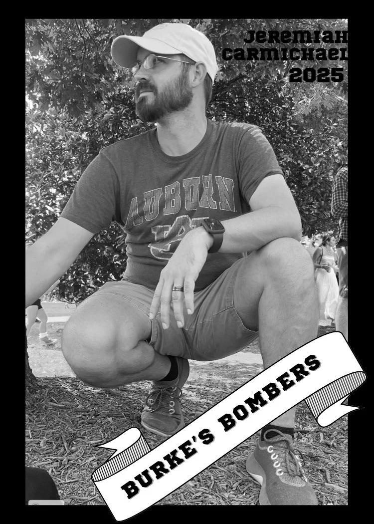 A man with a beard and glasses sitting on the ground outdoors, wearing a light-colored cap, a t-shirt with "AUBURN" on it, shorts, and sneakers, with a tree behind him. Text overlays include "Jeremiah Carmichael 2025" and "Burke's Bombers" on a ribbon at the bottom.