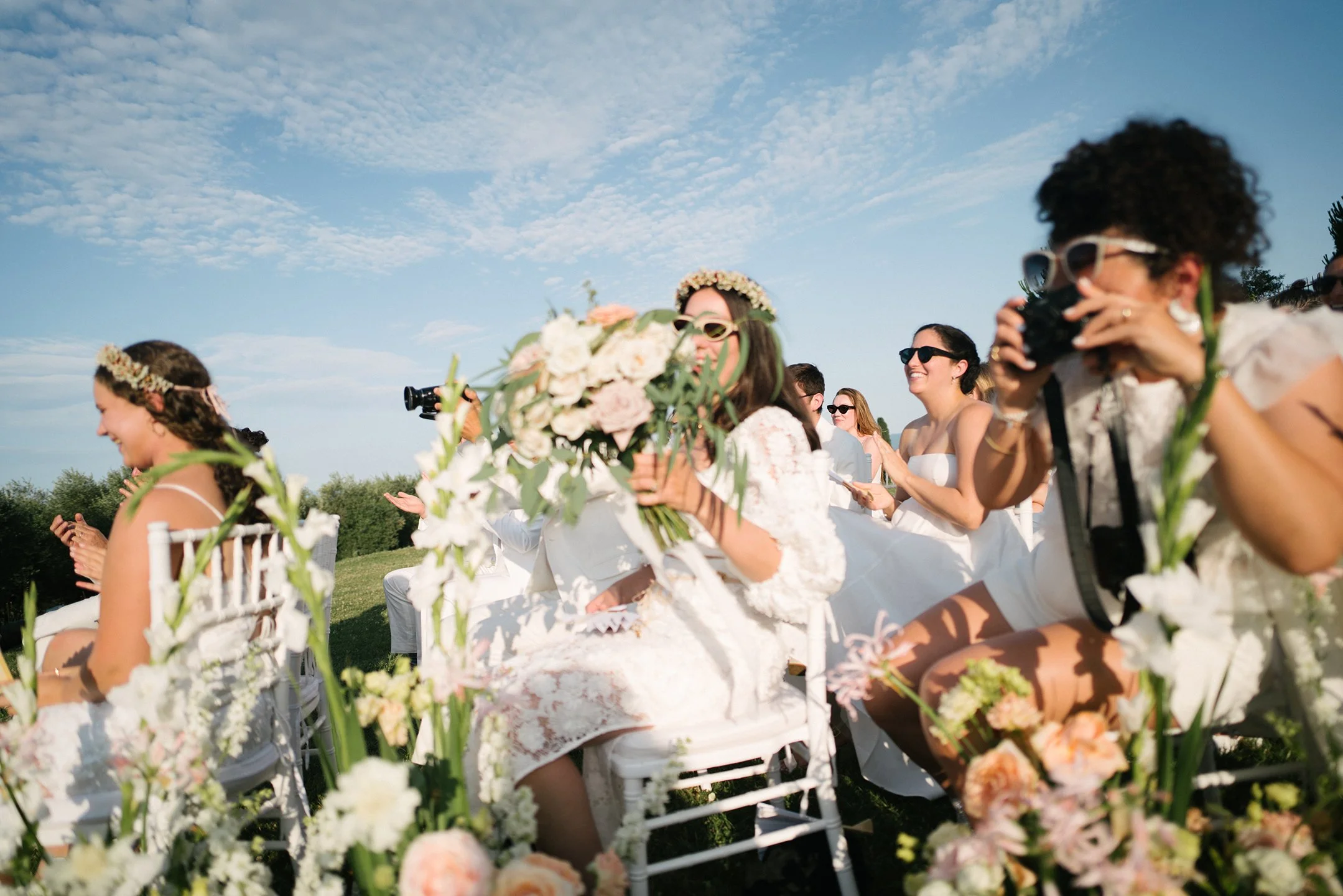 Maid of honor celebrating in the moments after the bride and groom are wed at a wedding ceremony at Villa Mangiacane in Tuscany.