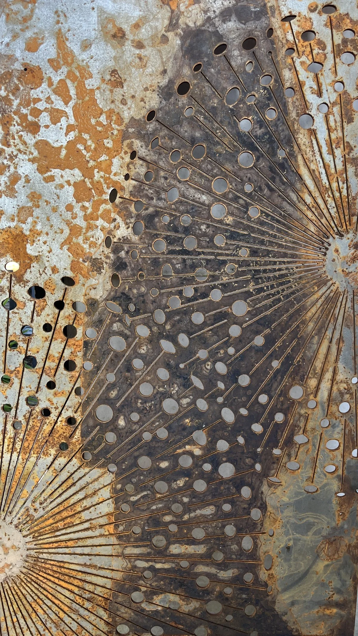 Decorative laser-cut metal cladding panel with floral design and patinated surface, illustrating bespoke architectural detailing by architects in Bath specialising in heritage, conservation, and listed building projects.