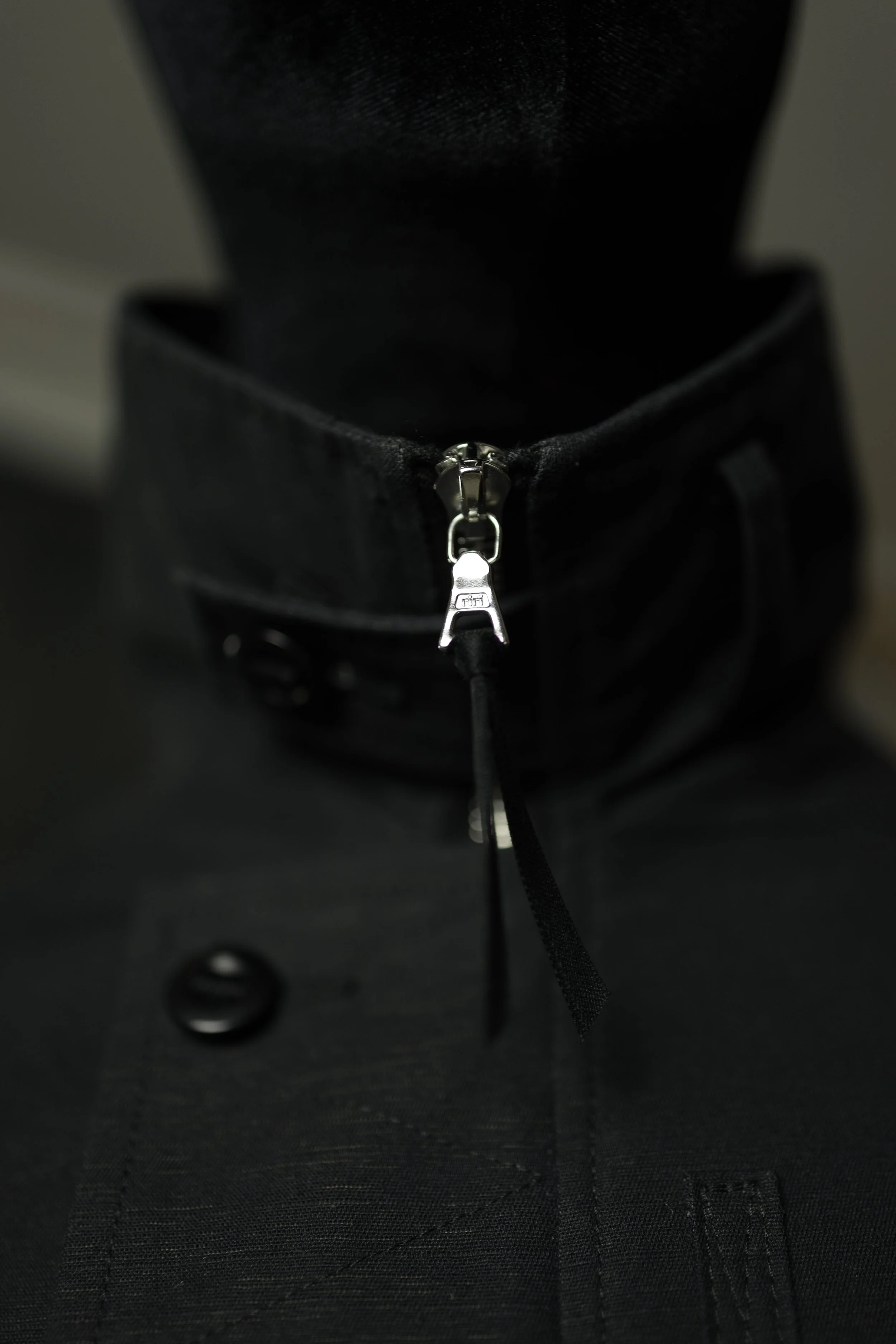 Close-up of Navigator Jacket concealed zipper closure with utility-inspired hardware detail.