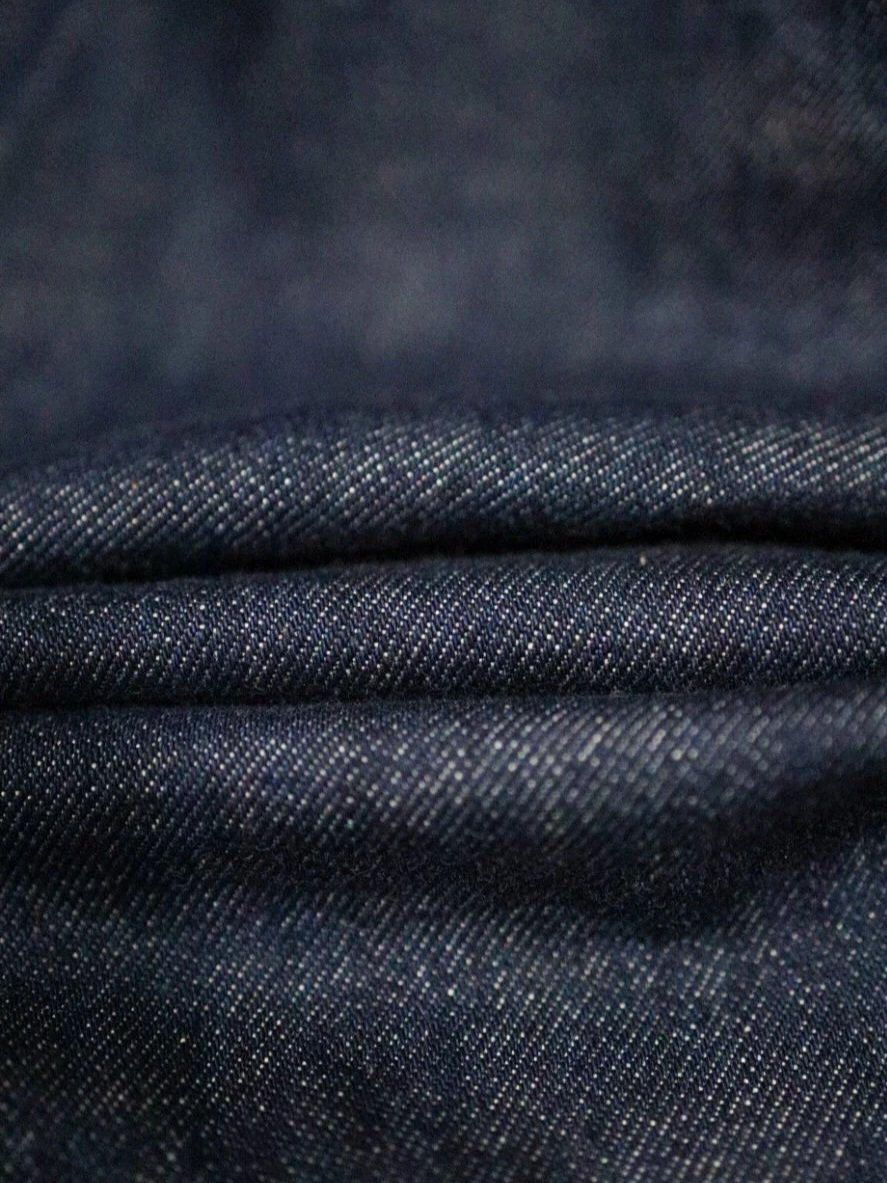 Close-up of 14oz American selvedge denim fabric showing indigo texture and weave detail