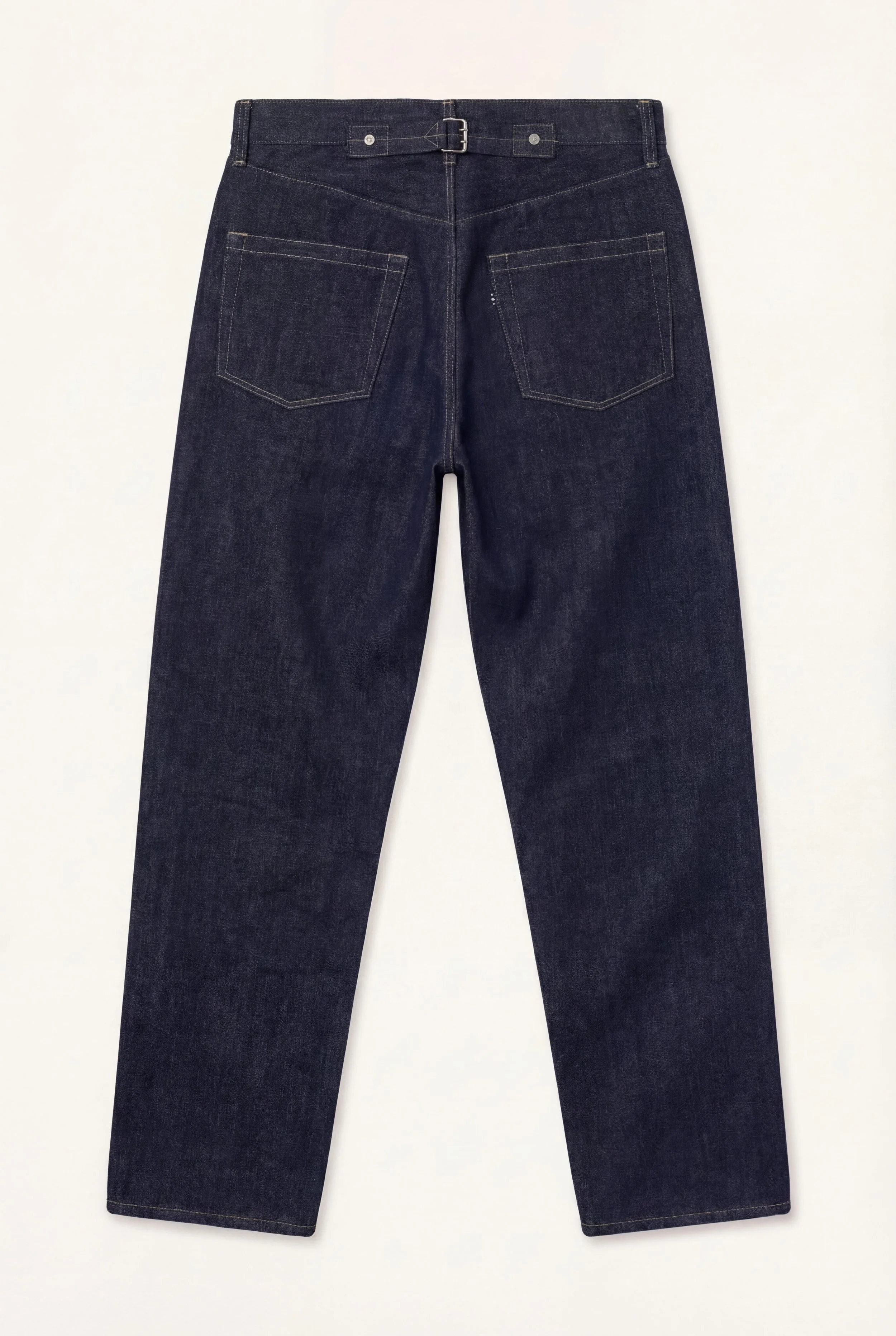 Back view of [ko'lon] Indigo selvedge denim jeans featuring classic five‑pocket layout, back cinch buckle, and straight‑leg silhouette