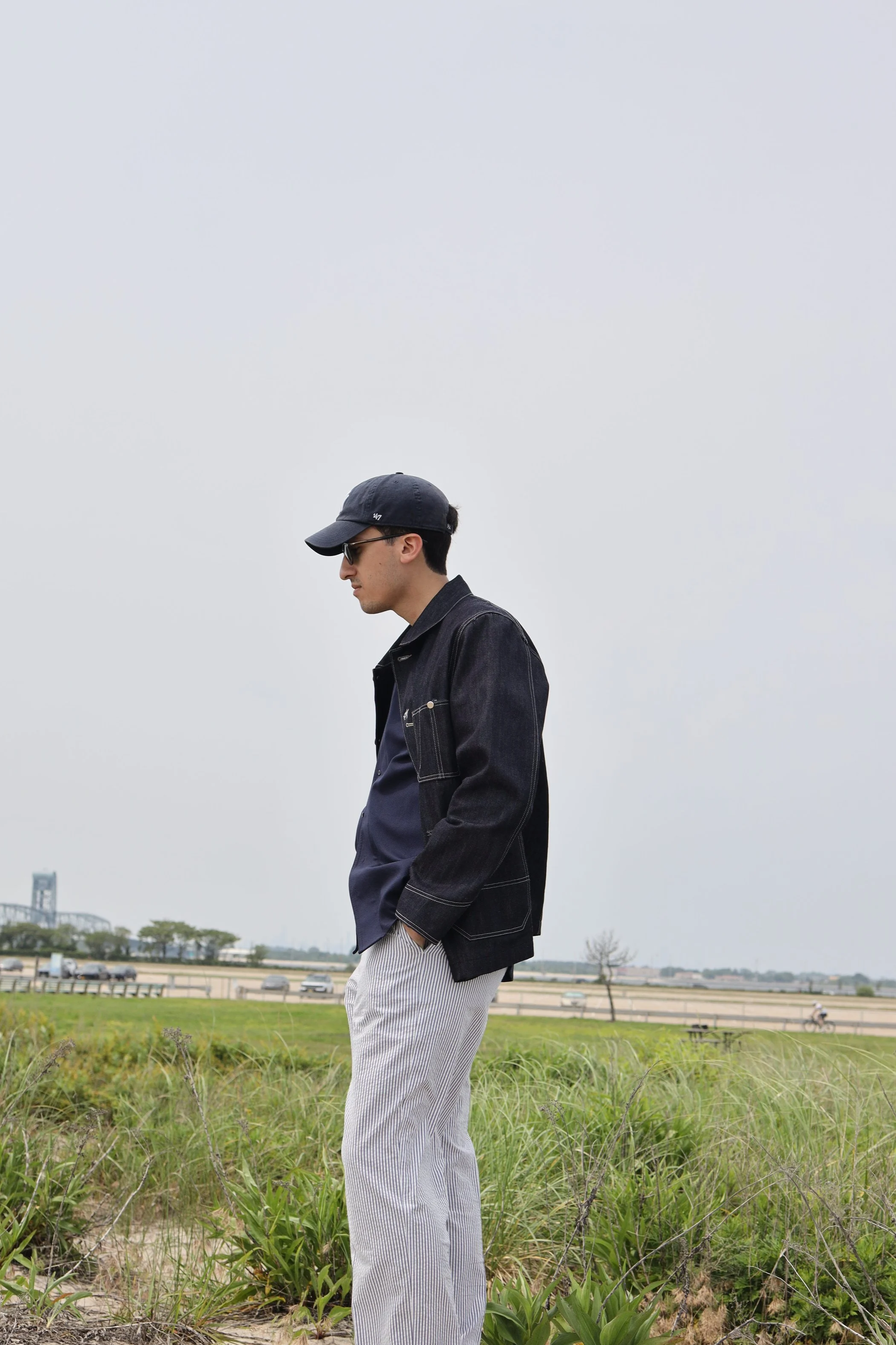 Selvedge denim coverall jacket worn on body in side profile