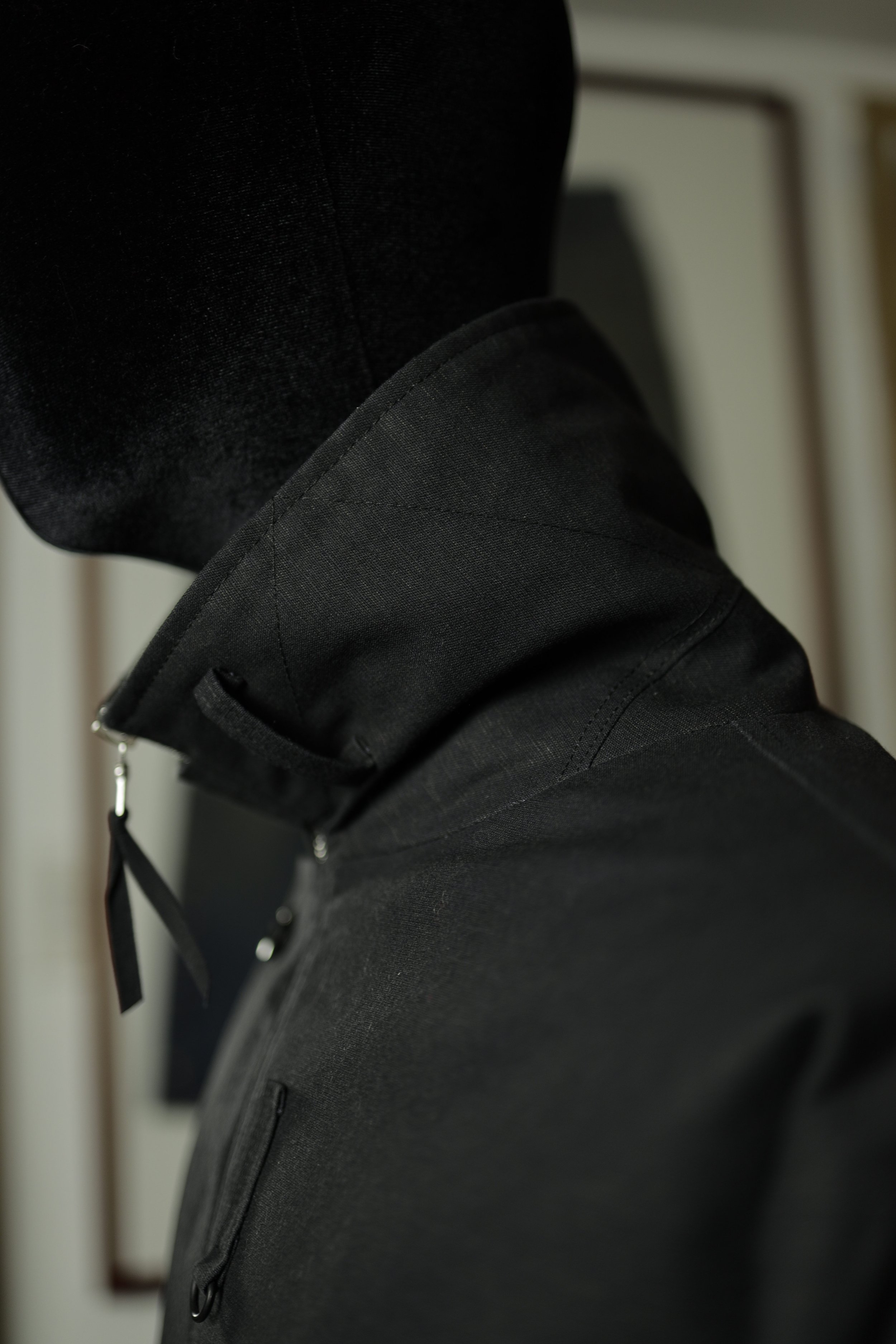 Close-up of Navigator Jacket collar constructed from black cotton ripstop with structured shape.
