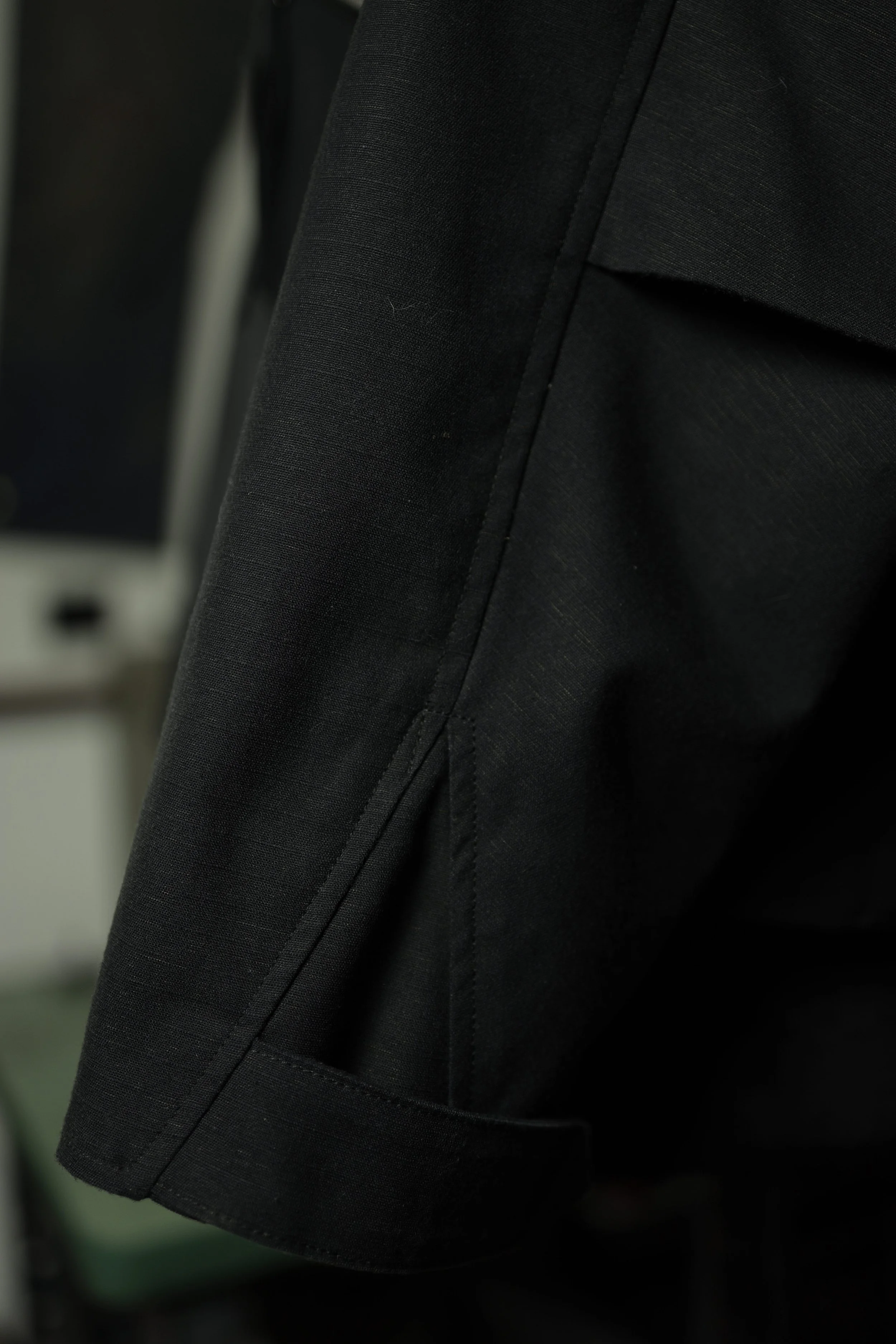 Navigator Jacket sleeve vent detail in black cotton ripstop fabric.