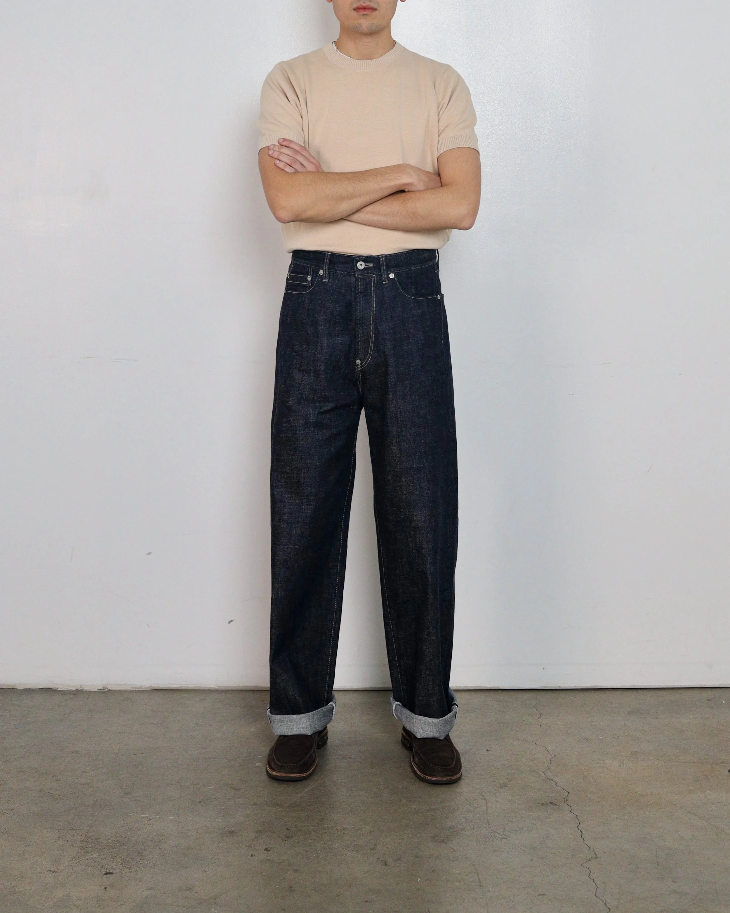 On‑body front view of indigo selvedge denim jeans by [ko’lōn], featuring a straight‑leg silhouette, classic five‑pocket design, and button fly closure.