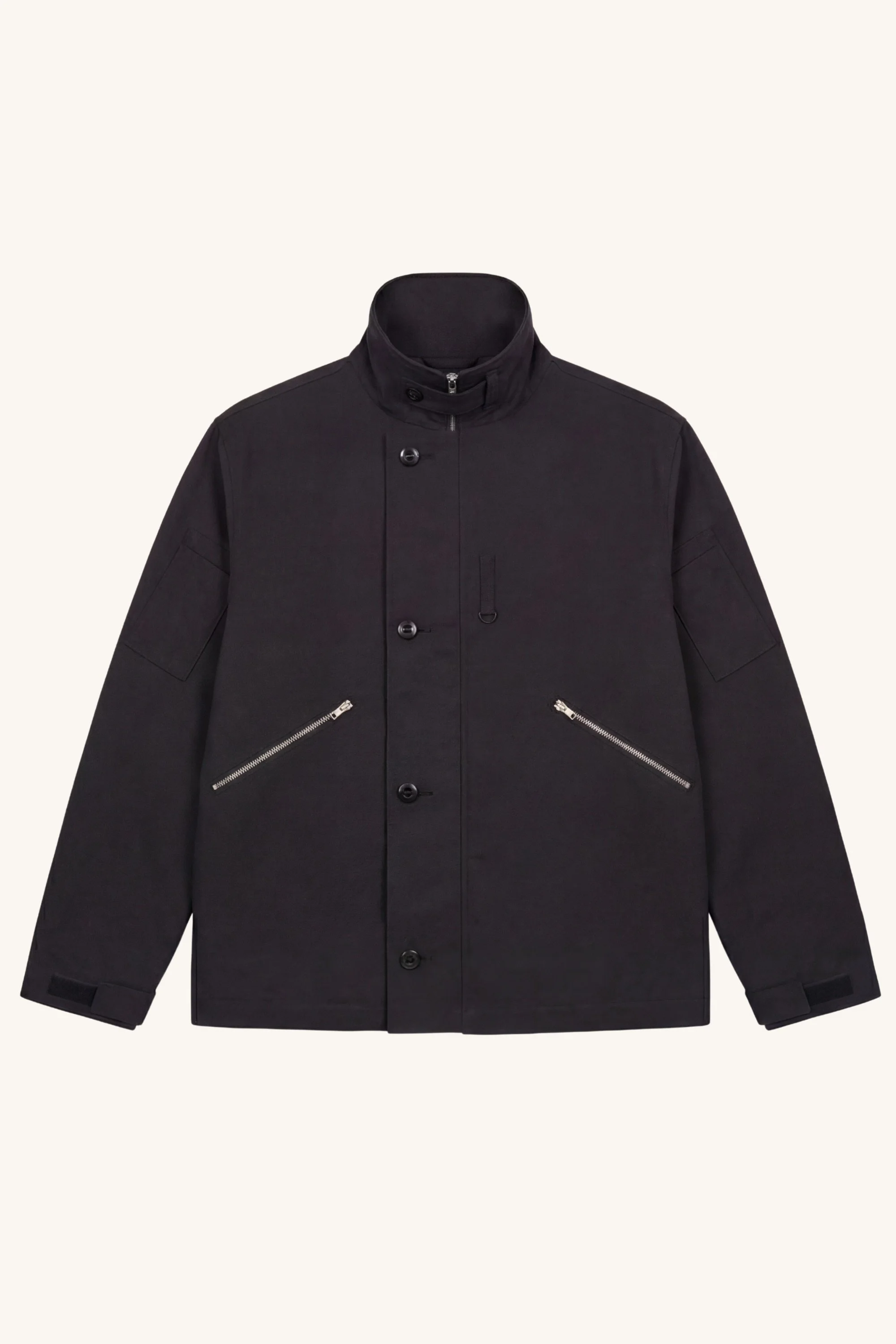 Front view of the [ko'lon] Navigator Jacket in black cotton ripstop featuring a concealed front closure, utility pockets, adjustable cuffs, and relaxed silhouette.